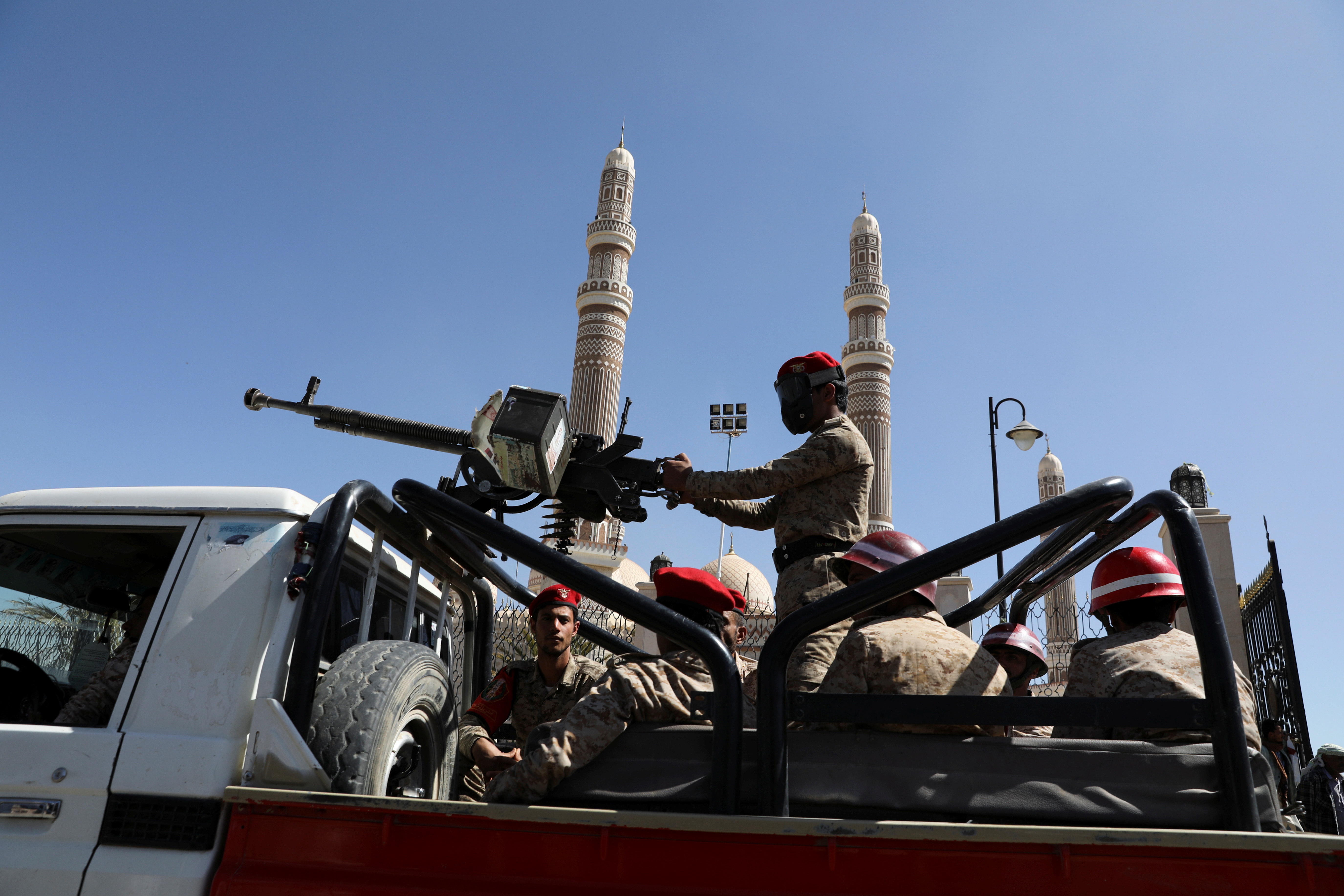 Military policemen ride on the back of a patrol truck at the site of a funeral of Houthi fighters killed during recent fighting against government forces, in Sanaa, Yemen December 6, 2021. REUTERS/Khaled Abdullah