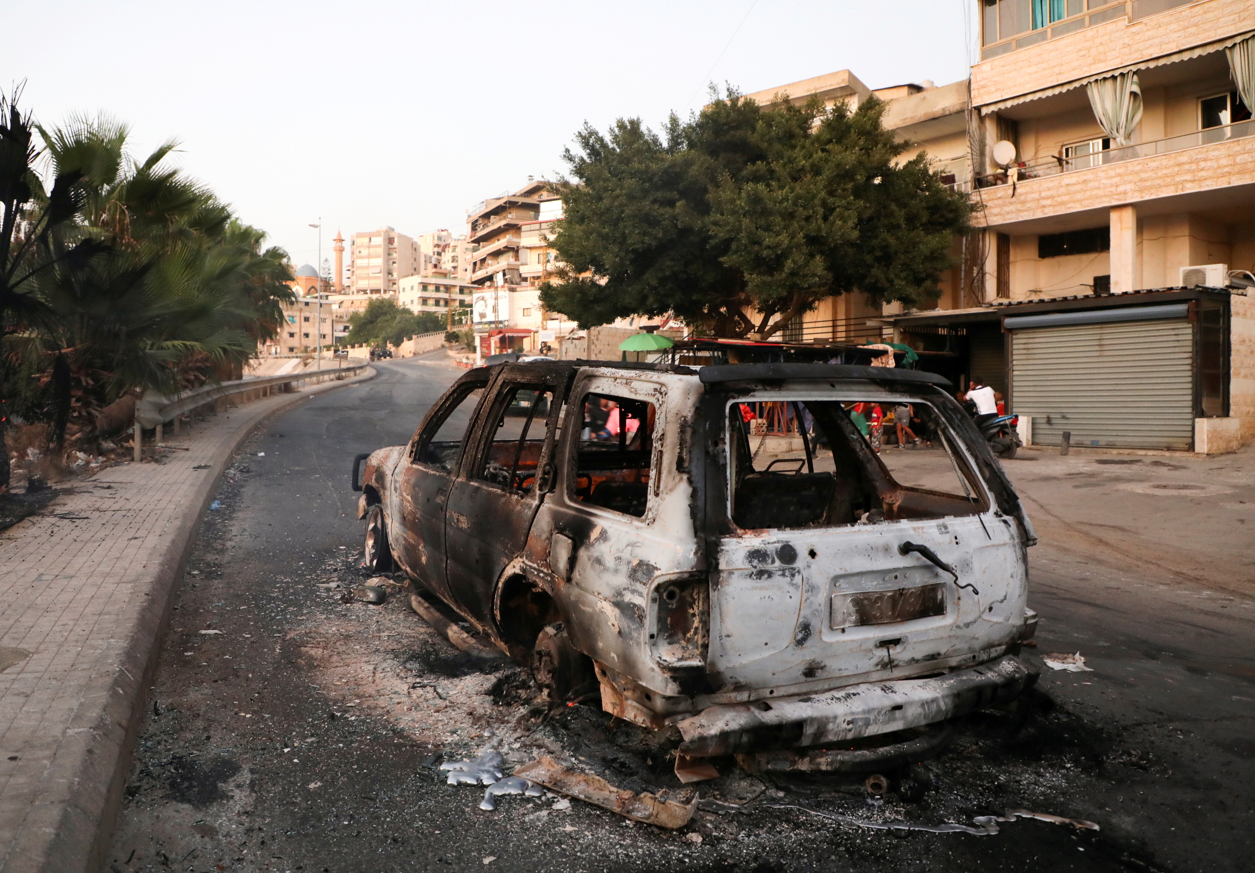 A burnt car is seen after an ambush on Shi'ite mourners, in Khaldeh