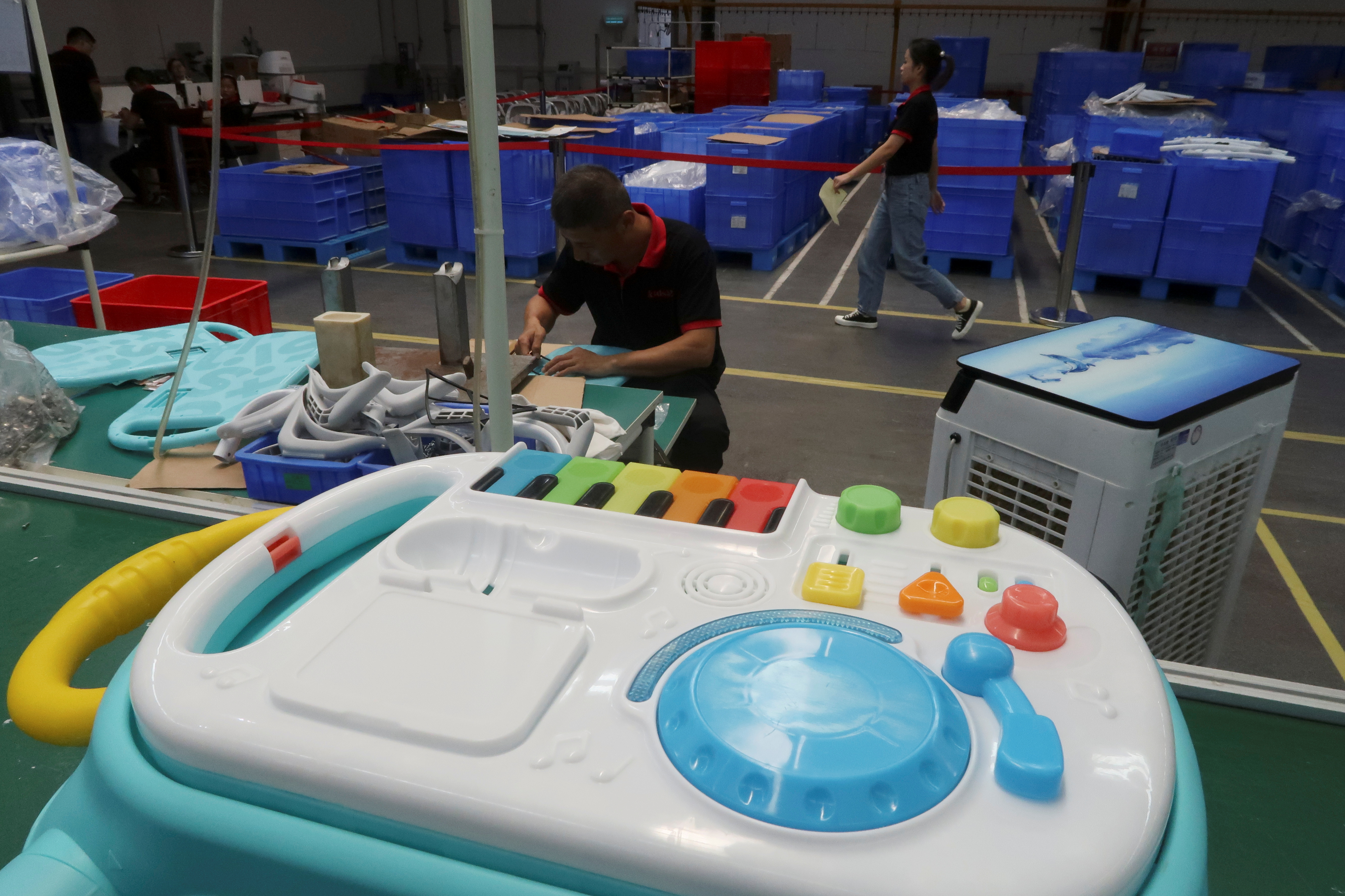Employees work on the production line of Kids II Inc at a factory in Jiujiang