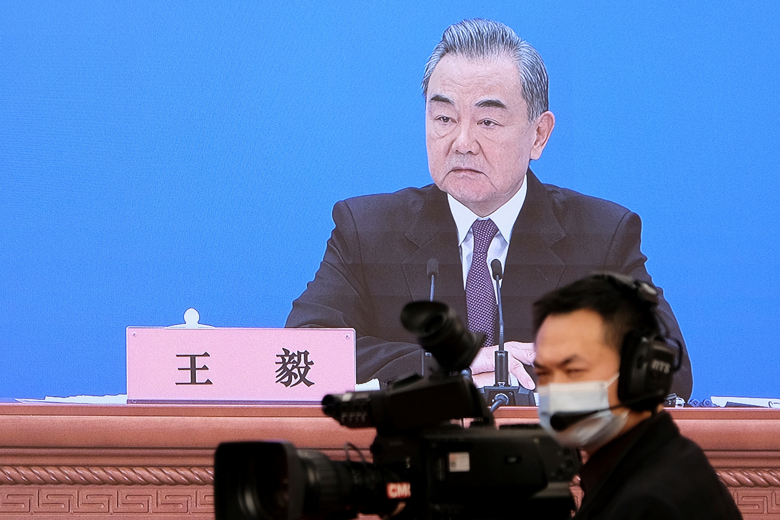 Chinese State Councilor and Foreign Minister Wang Yi attends a news conference via video link in Beijing