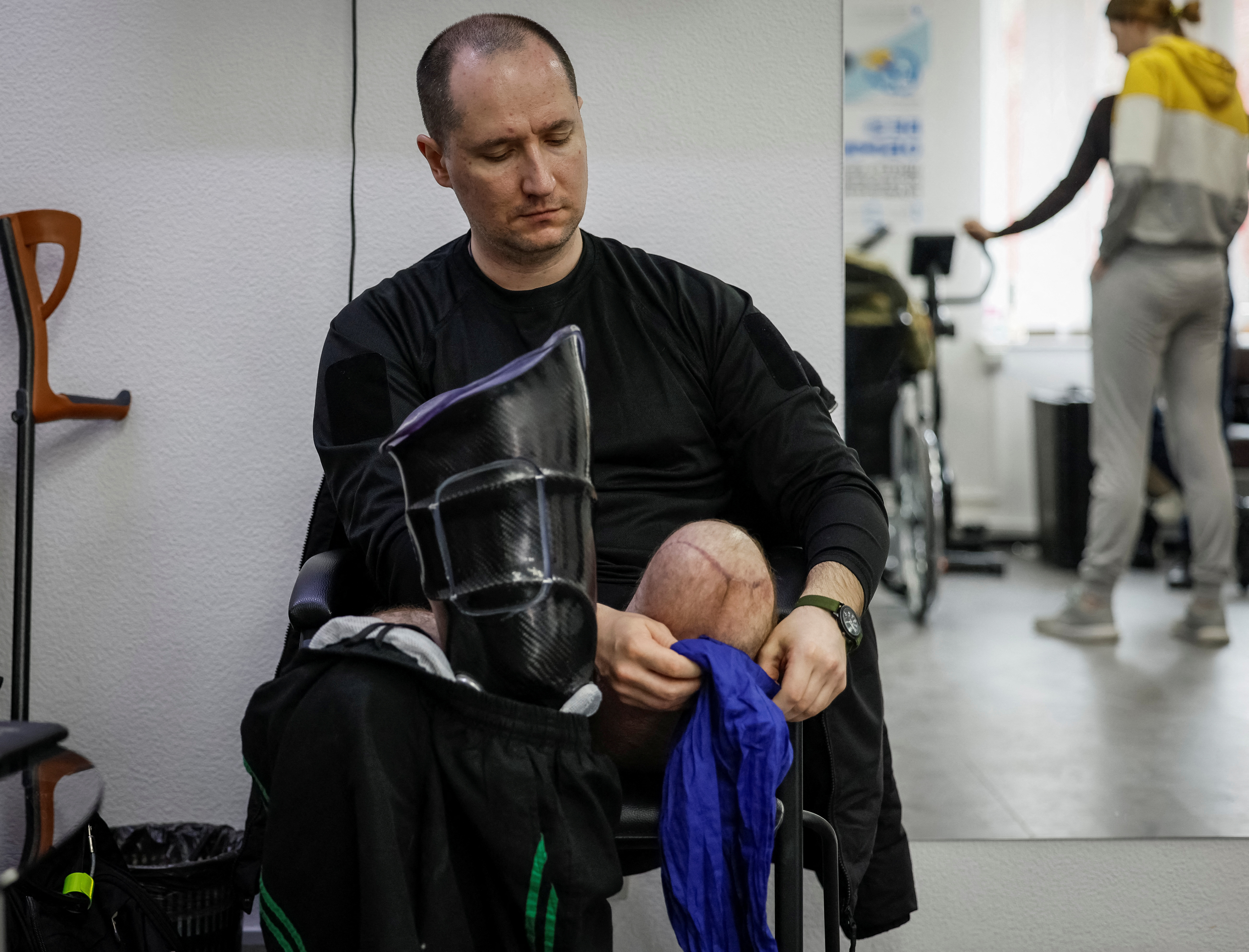 A patient of a prosthetics clinic, who lost his leg in the war, prepares to try on his prosthesis after fitting it in the clinic in Kyiv