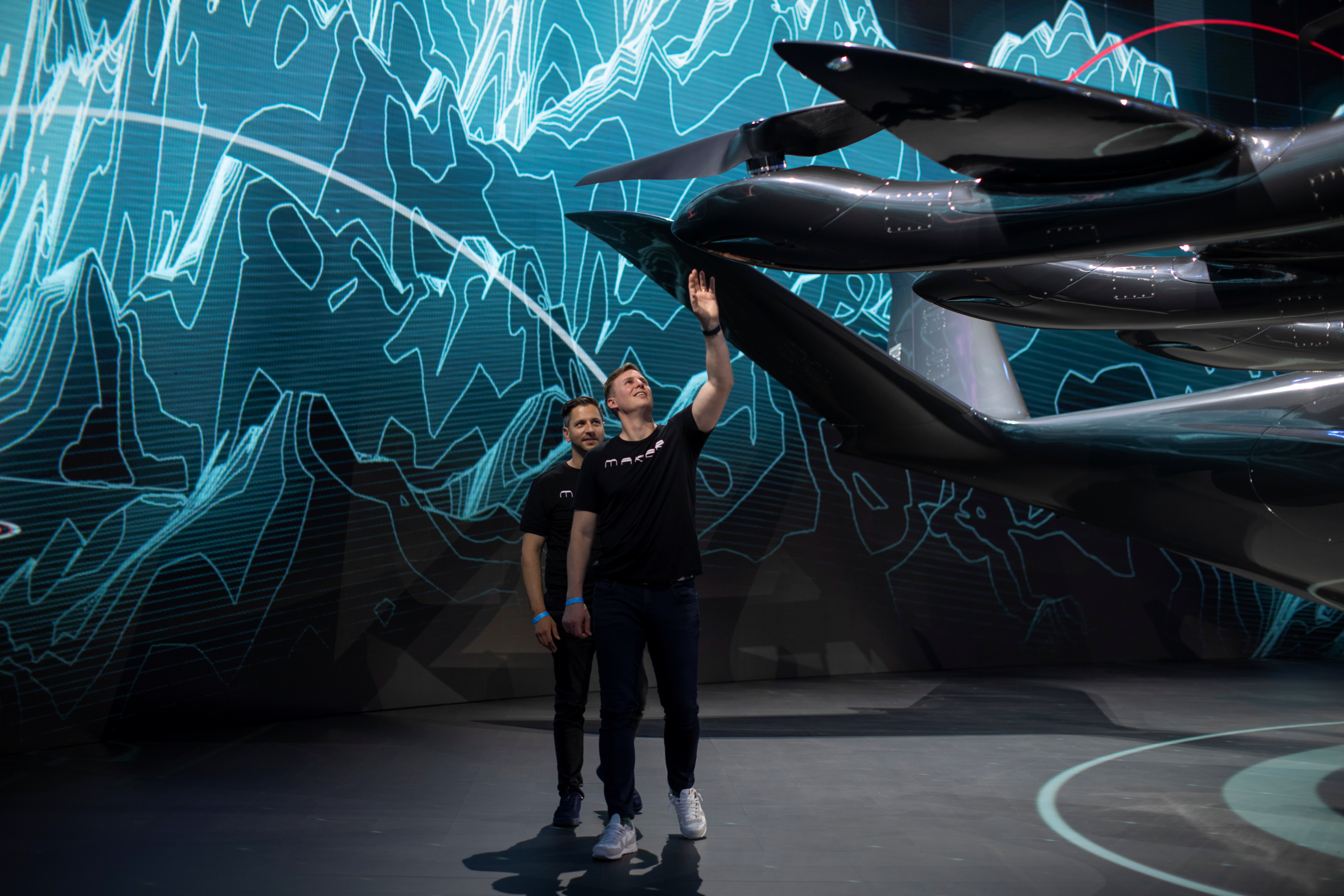 Brett Adcock and Adam Goldstein (L) co-founders and co-CEOs of flying taxi company Archer Aviation, walk around their invention as they rehearse for the unveiling of their all-electric aircraft from a facility in Hawthorne, California, U.S. June 8, 2021. Picture taken June 8, 2021.     REUTERS/Mike Blake