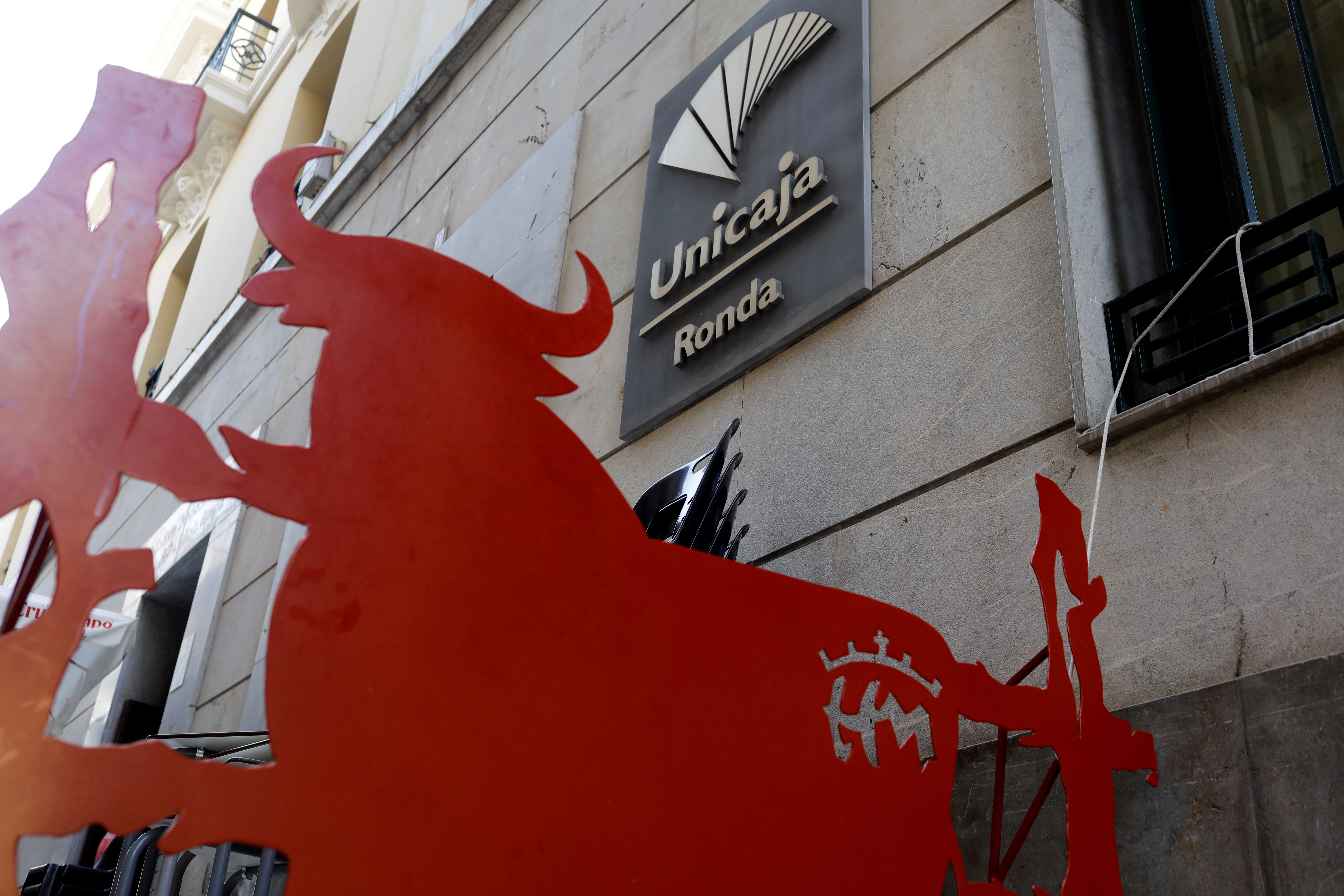 The logo of Unicaja bank is seen on the facade of a Unicaja bank branch in Ronda, southern Spain, September 7, 2021. REUTERS/Jon Nazca//File Photo