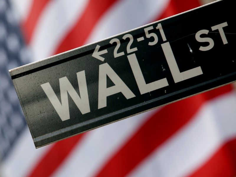 A street sign is seen in front of the New York Stock Exchange on Wall Street in New York