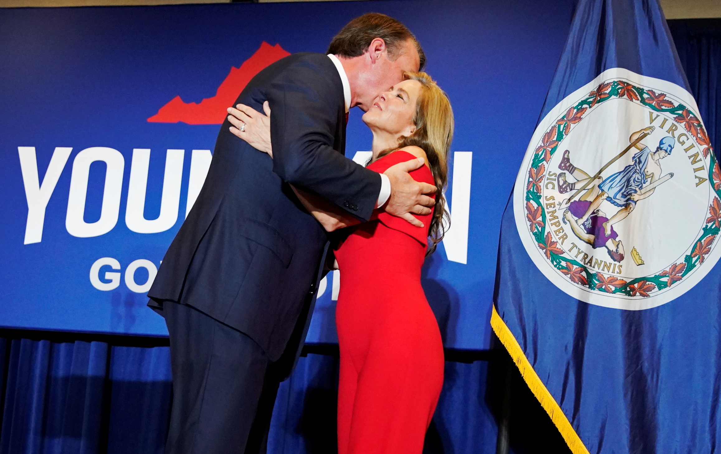 Virginia Republican gubernatorial nominee Glenn Youngkin hugs his wife Suzanne after addressing supporters during his election night party at a hotel in Chantilly, Virginia, U.S., November 3, 2021. REUTERS/ Elizabeth Frantz