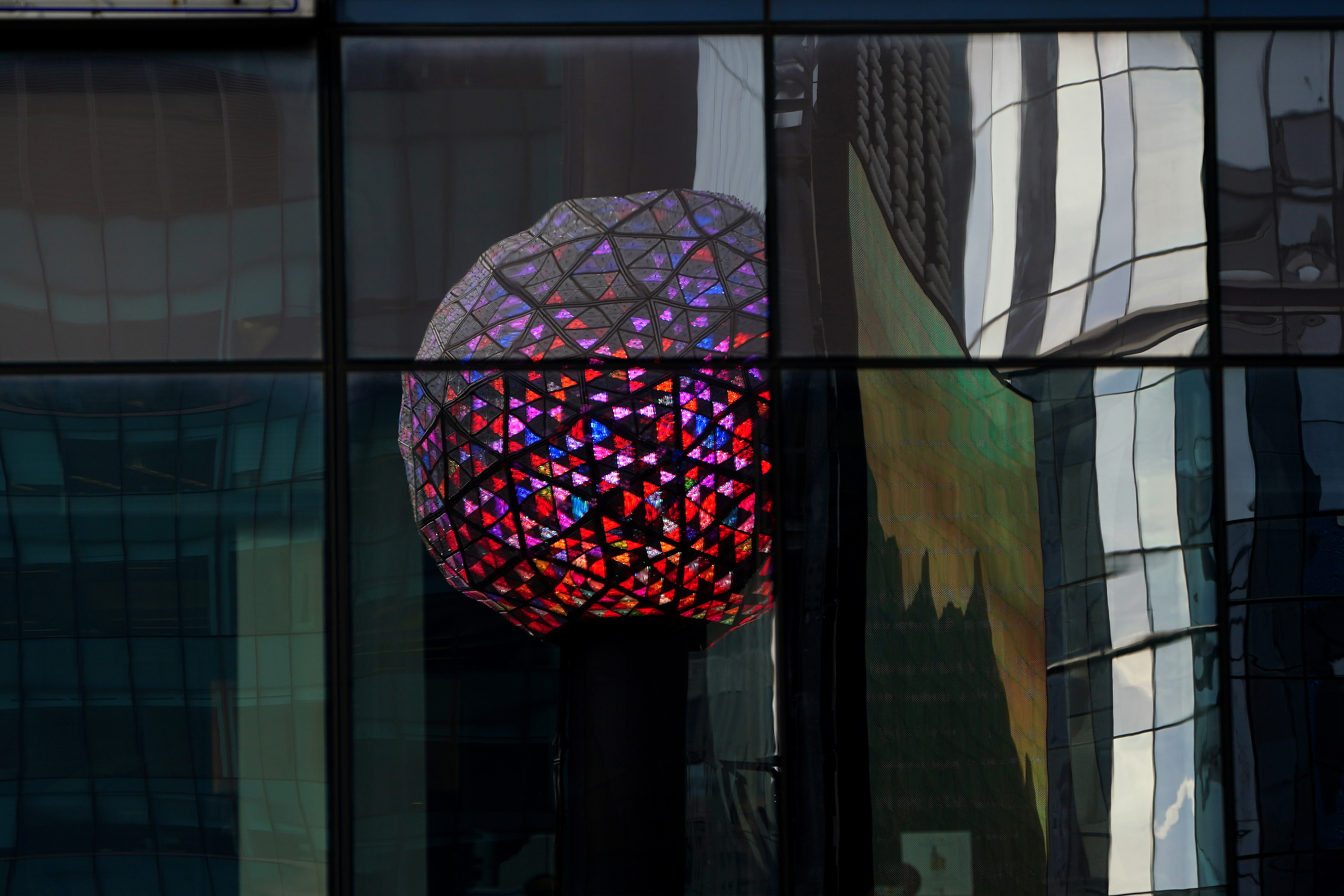 The Times Square ball is reflected in a nearby building as it is tested out for the media ahead of the New Year's celebration in Times Square
