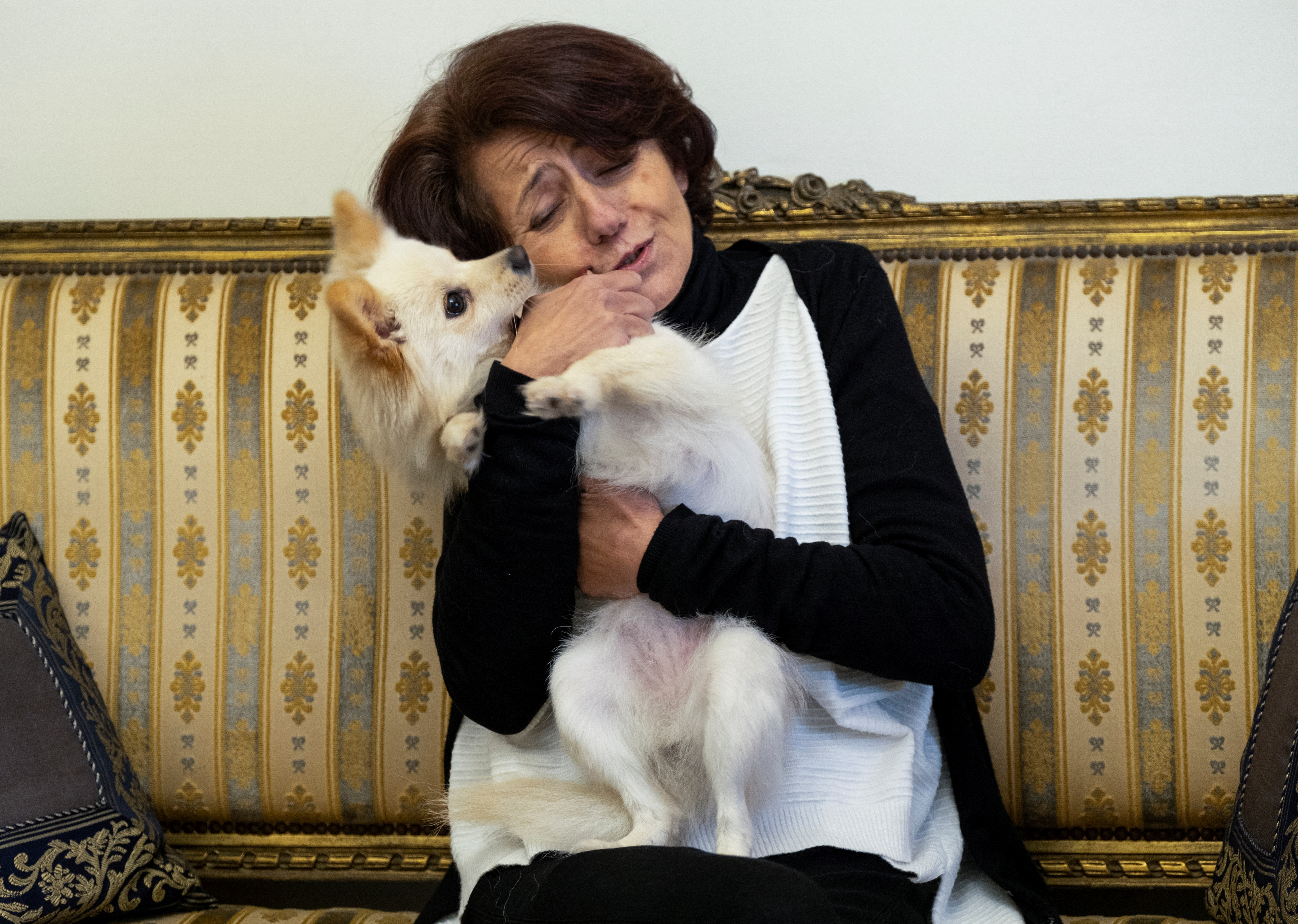 Marie-Therese Chamma, a breast cancer survivor holds her dog during an interview with Reuters at her home in Beit Mery