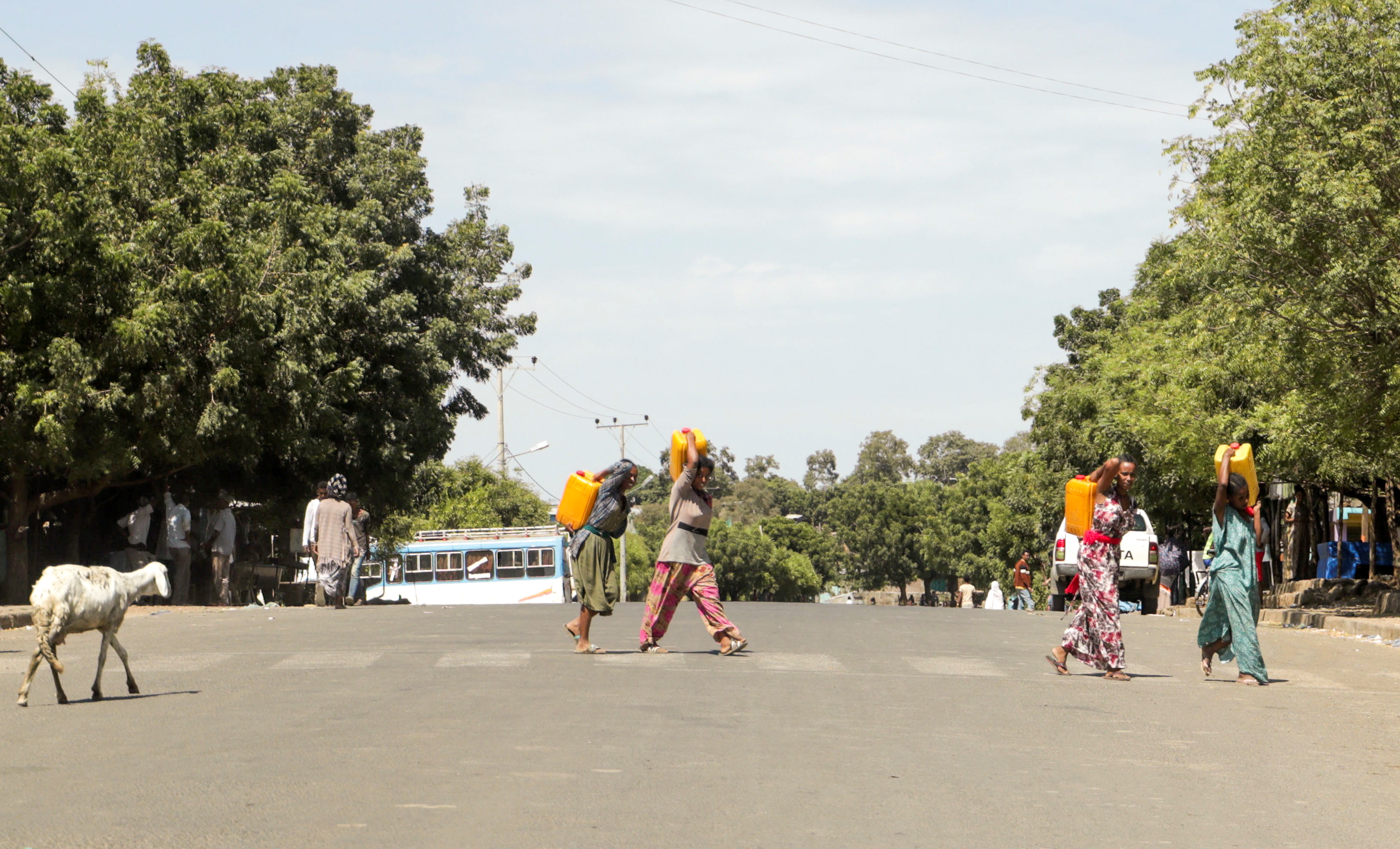 Residents carry jerrycans along a street in Dansha town in Tigray Region