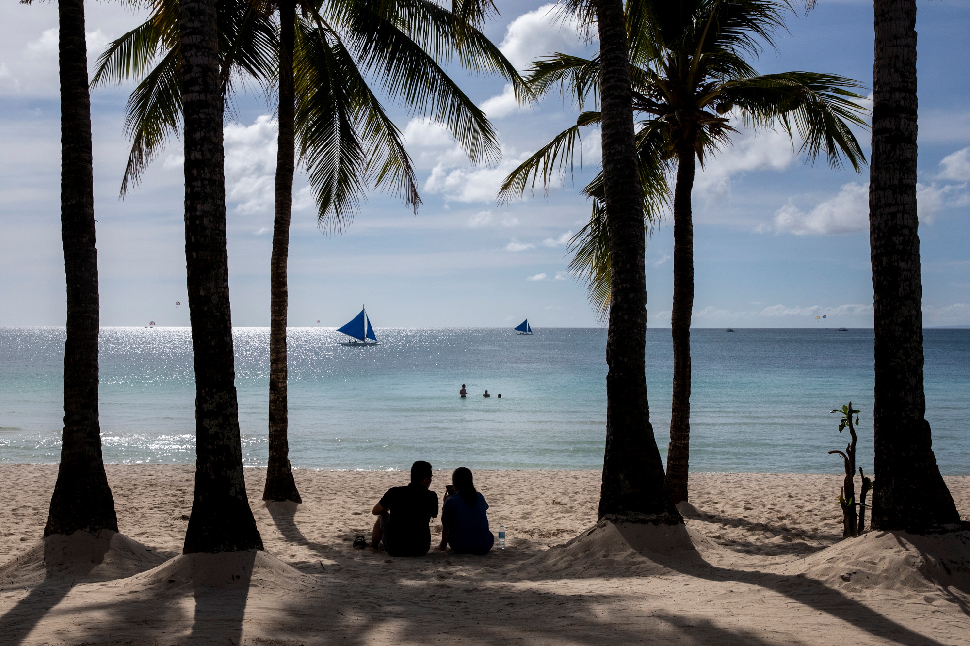 A couple enjoys a view of White Beach amid the coranavirus disease (COVID-19) outbreak, in Boracay Island, Aklan province, Philippines, November 29, 2021. REUTERS/Eloisa Lopez