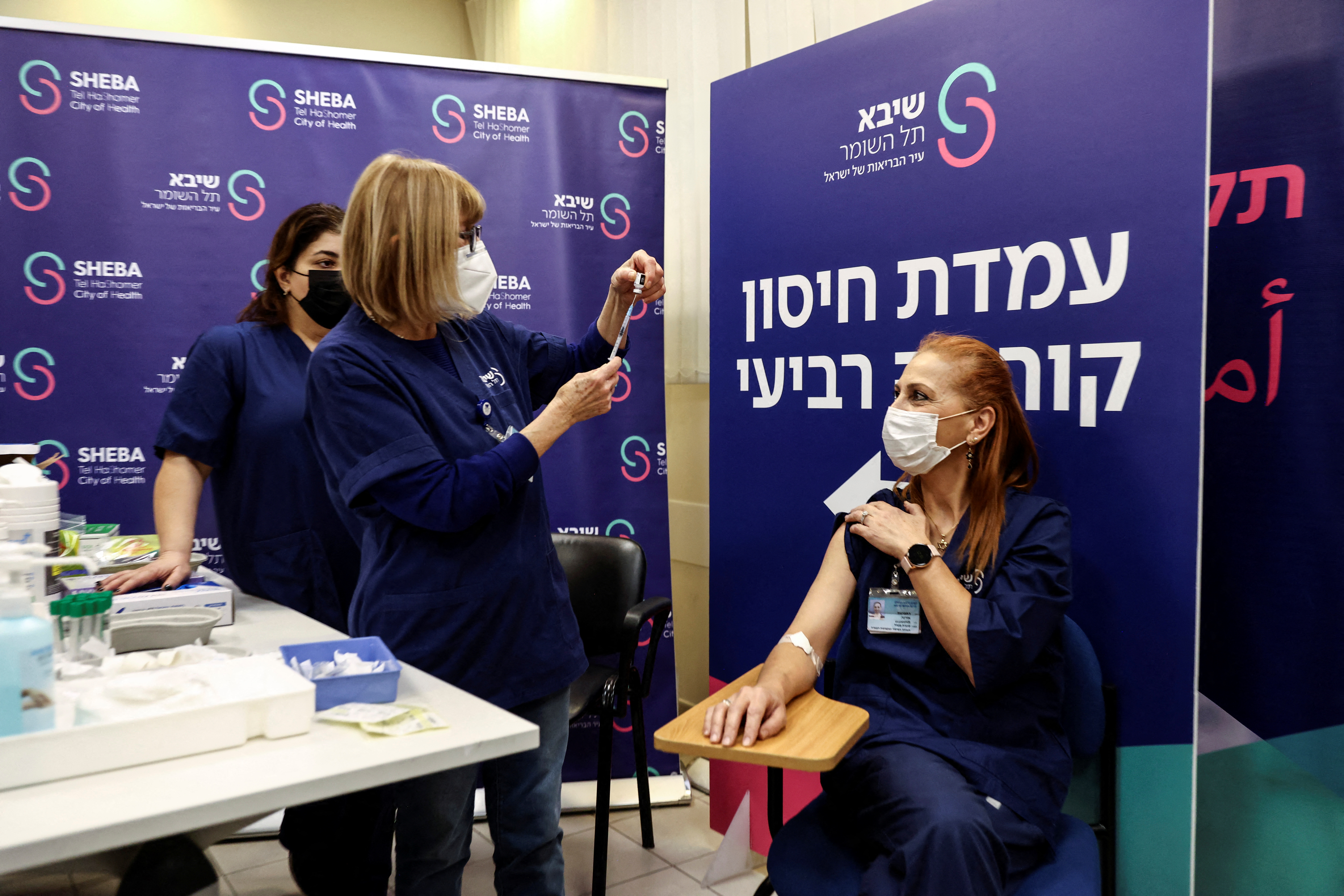 A medical worker receives a fourth dose of coronavirus disease (COVID-19) vaccine as part of a trial in Israel, as Health Ministry is considering offering the second booster to the elderly and immunocompromised at Sheba Medical Center in Ramat Gan
