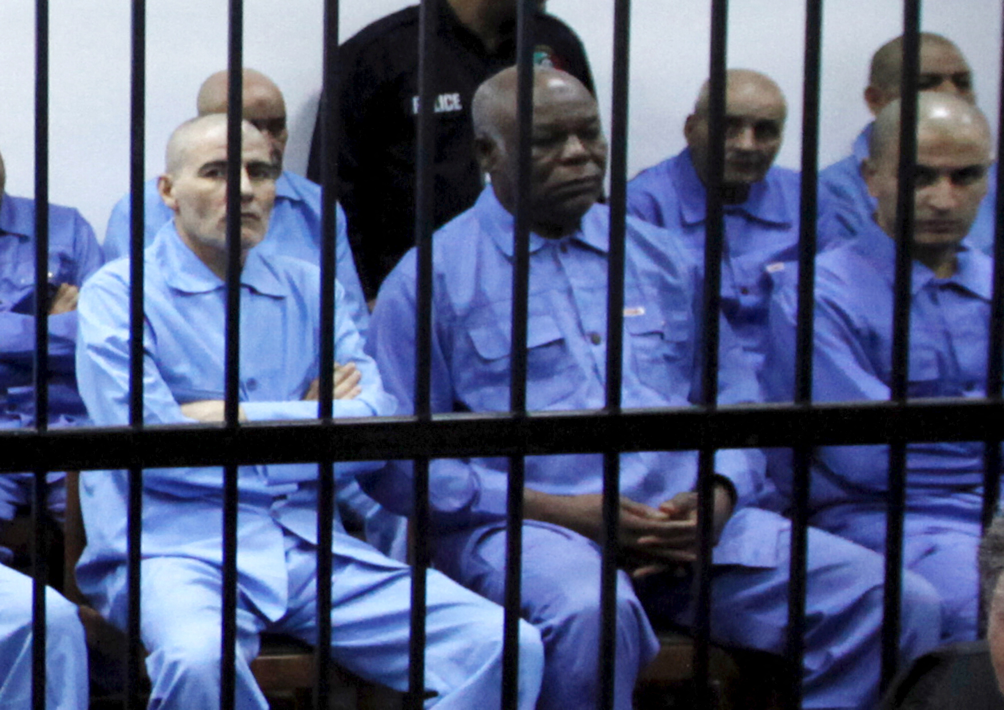 Abu Agila Mohammad Mas'ud Kheir Al-Marimi sits behind bars during a hearing at a courtroom in Tripoli