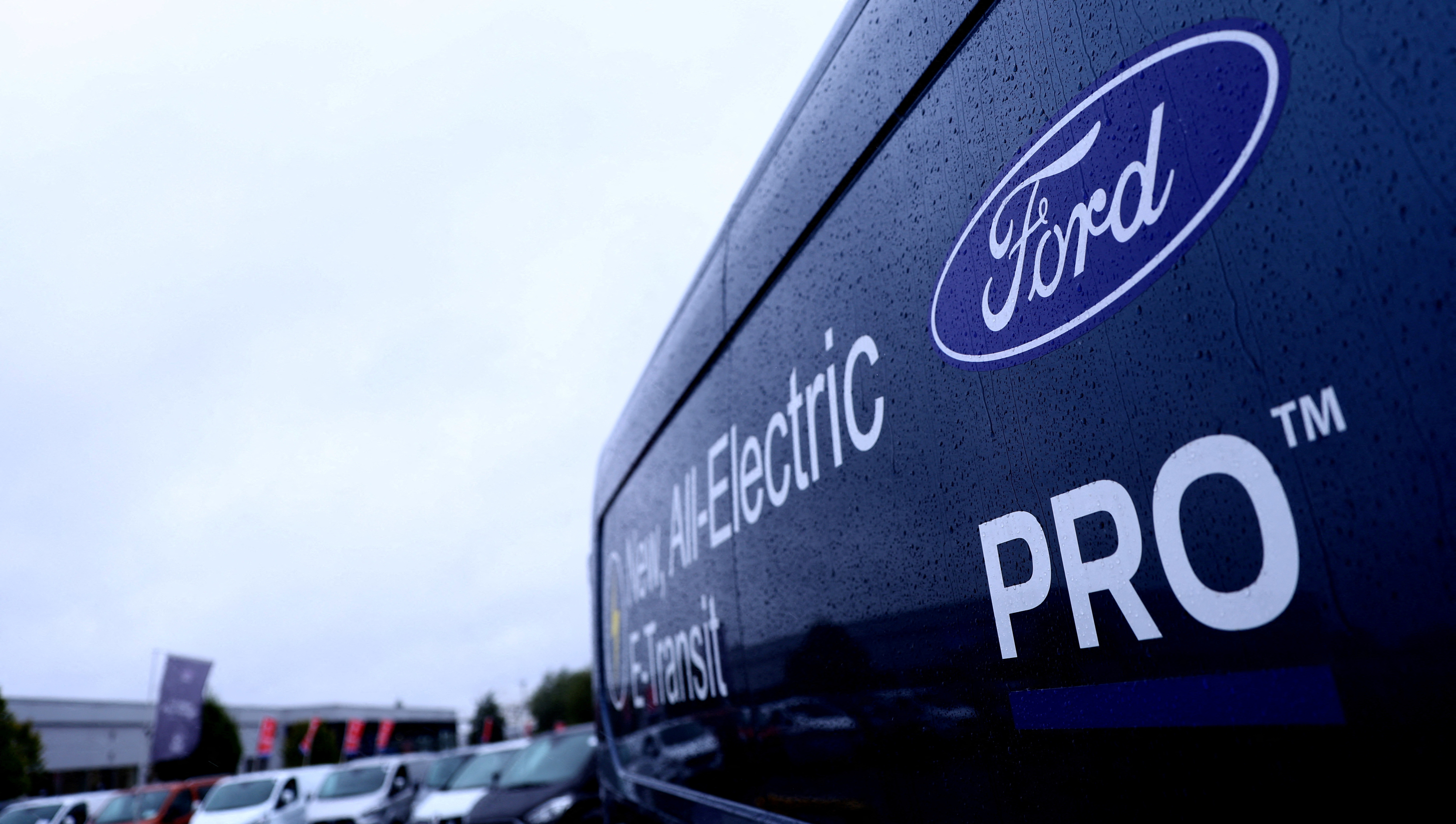 A Ford Electric E-Transit is displayed on a Ford dealership forecourt