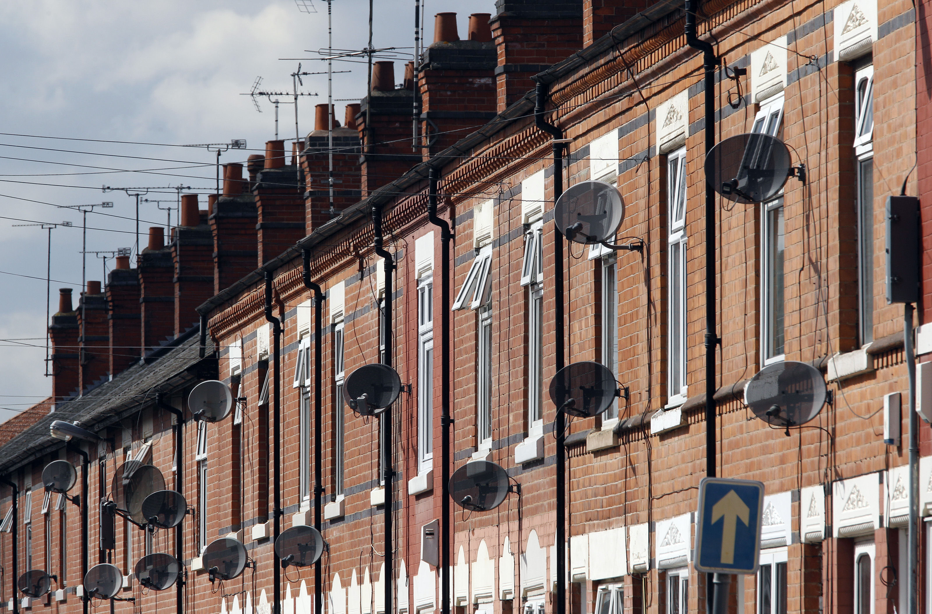 Satellite television dishes are seen fixed to a row of terraced houses in Leicester
