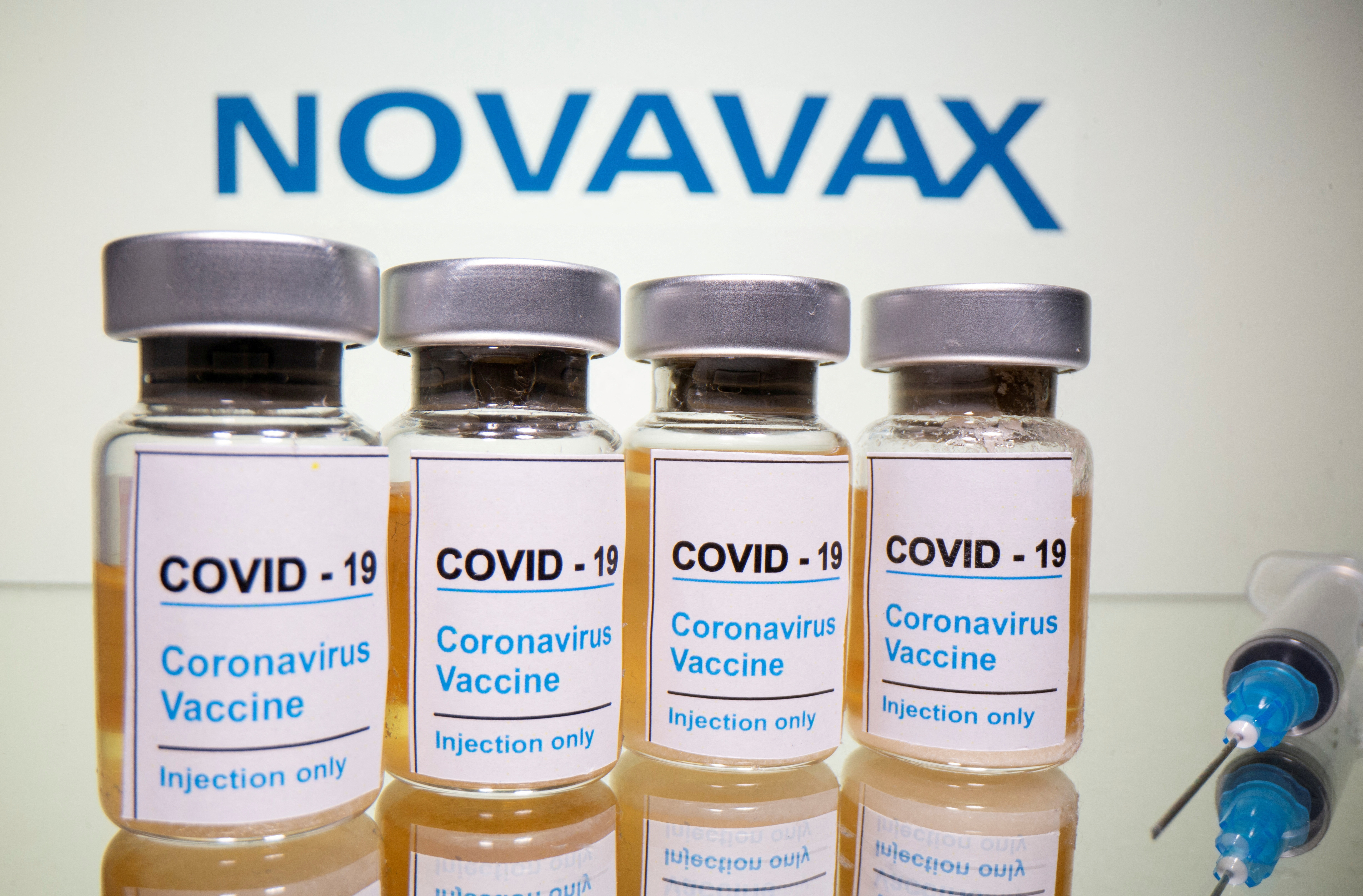 FILE PHOTO: Vials and medical syringe are seen in front of Novavax logo in this illustration
