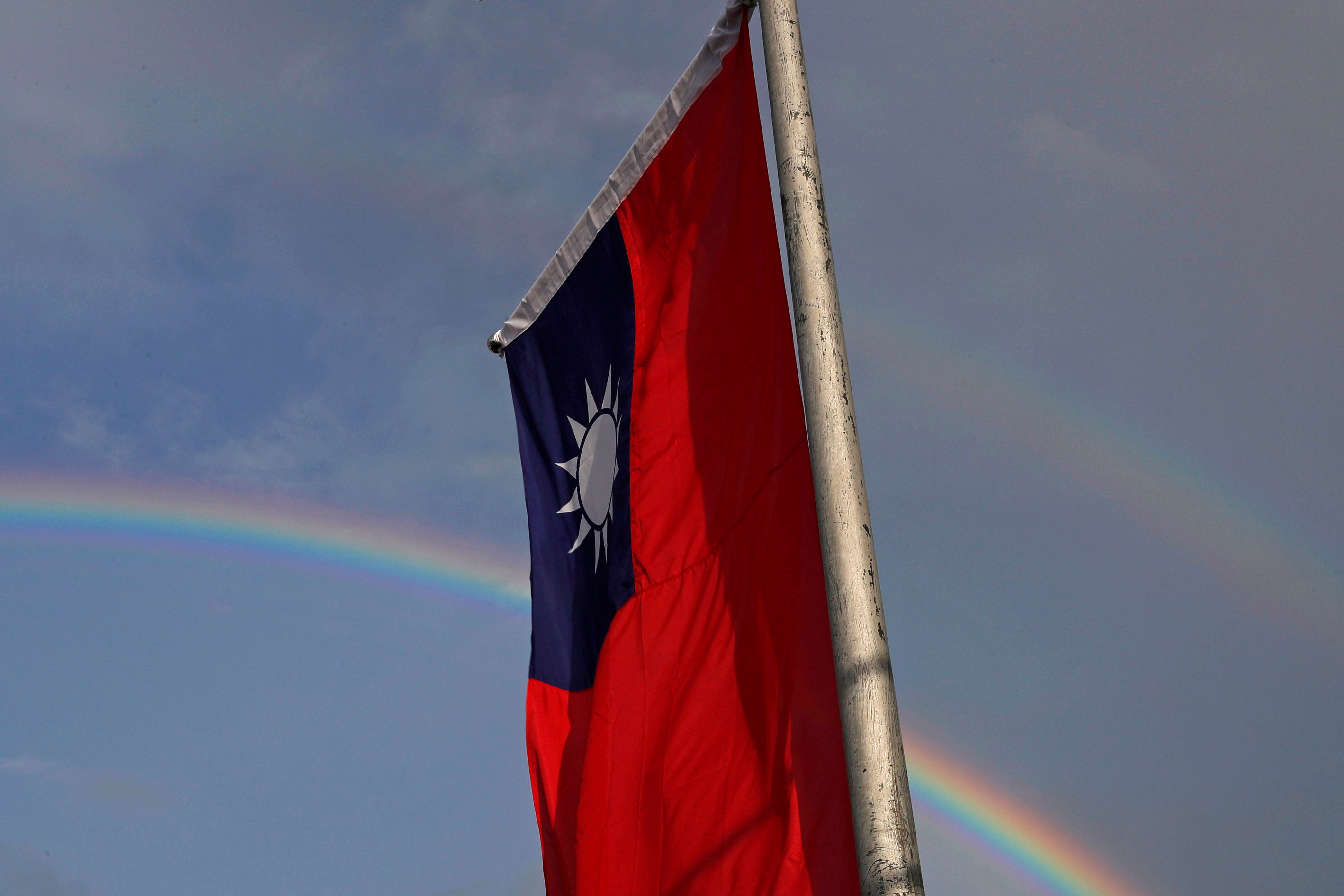 A double rainbow is seen behind Taiwanese flag during the National Day celebrations in Taipei, Taiwan, October 10, 2017. REUTERS/Tyrone Siu