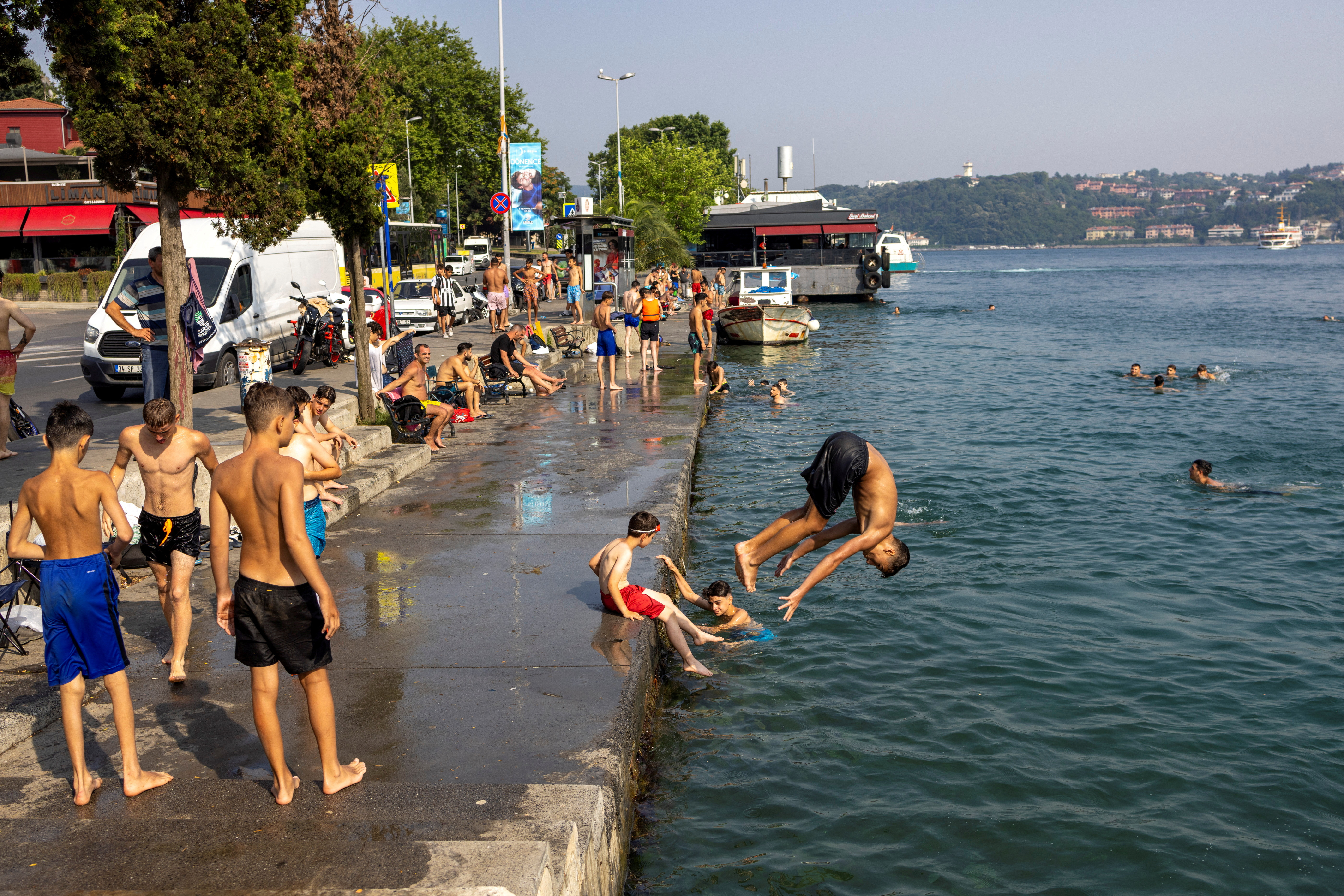 People cool off by the Bosphorus to escape hot weather in Istanbul