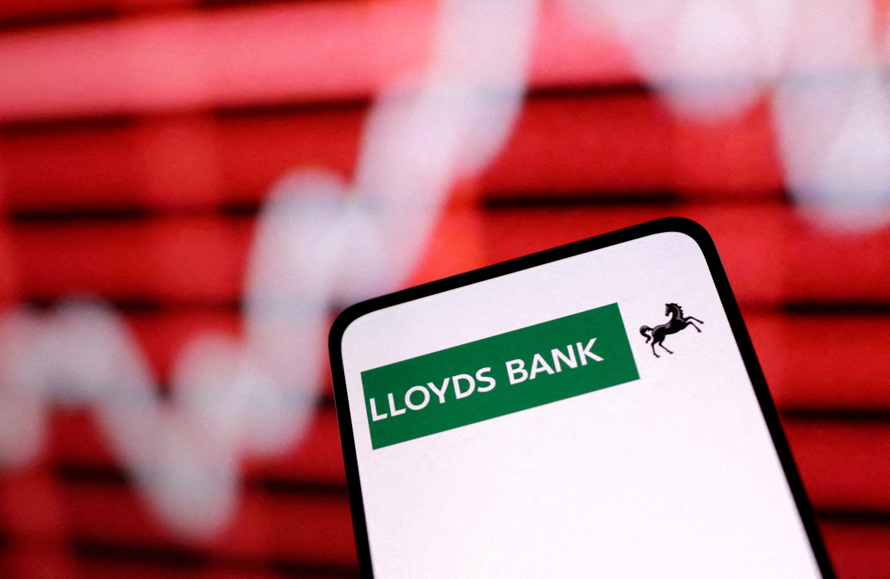 Illustration shows Lloyds Bank logo and rising stock graph