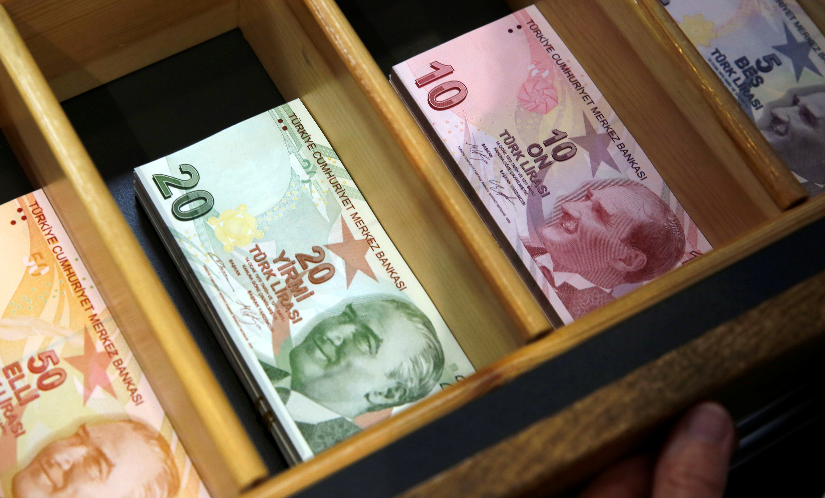 Turkish lira banknotes are pictured at a currency exchange office in Istanbul