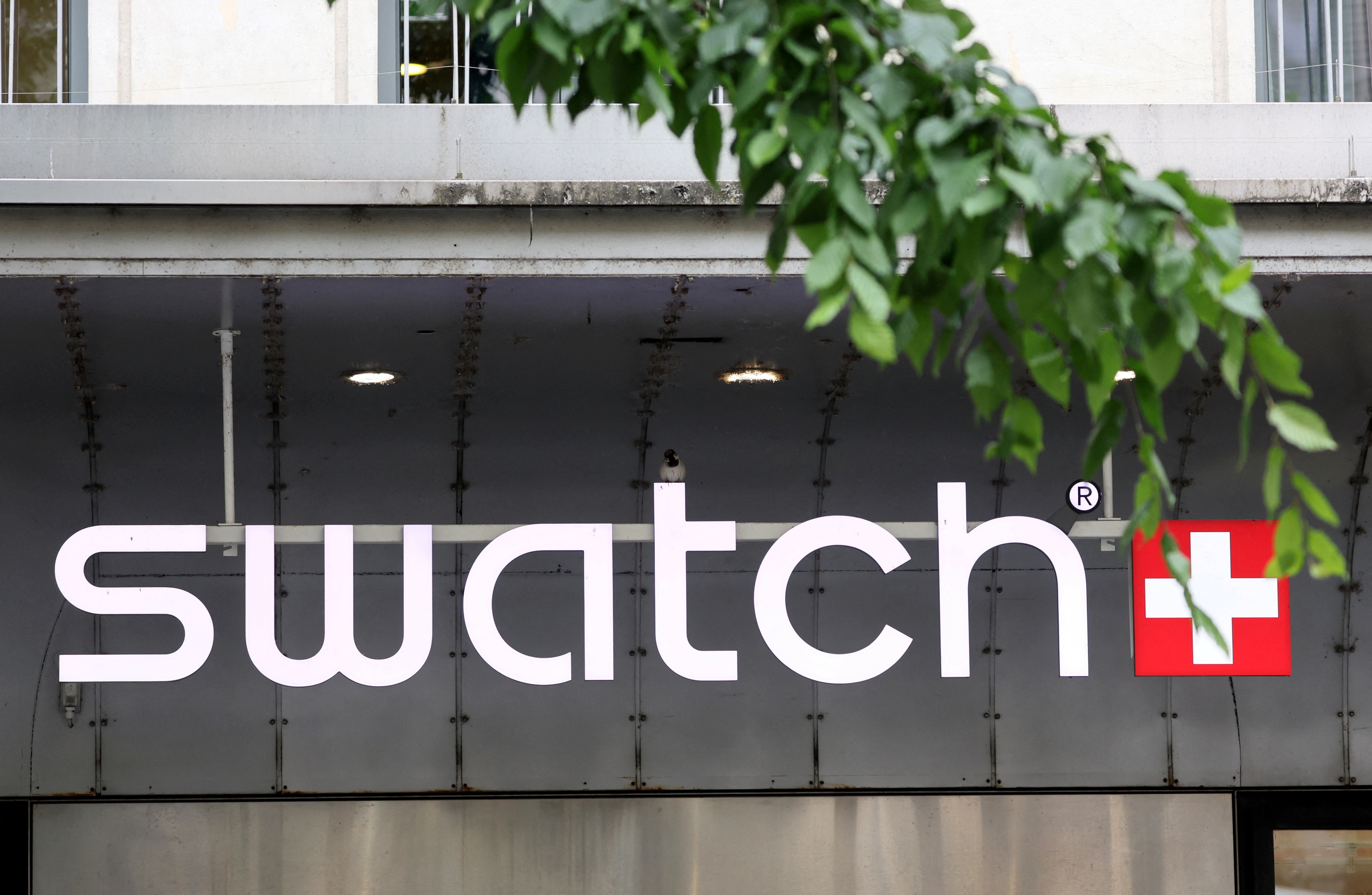 A logo of Swiss watch maker Swatch Group is pictured on a store in Geneva