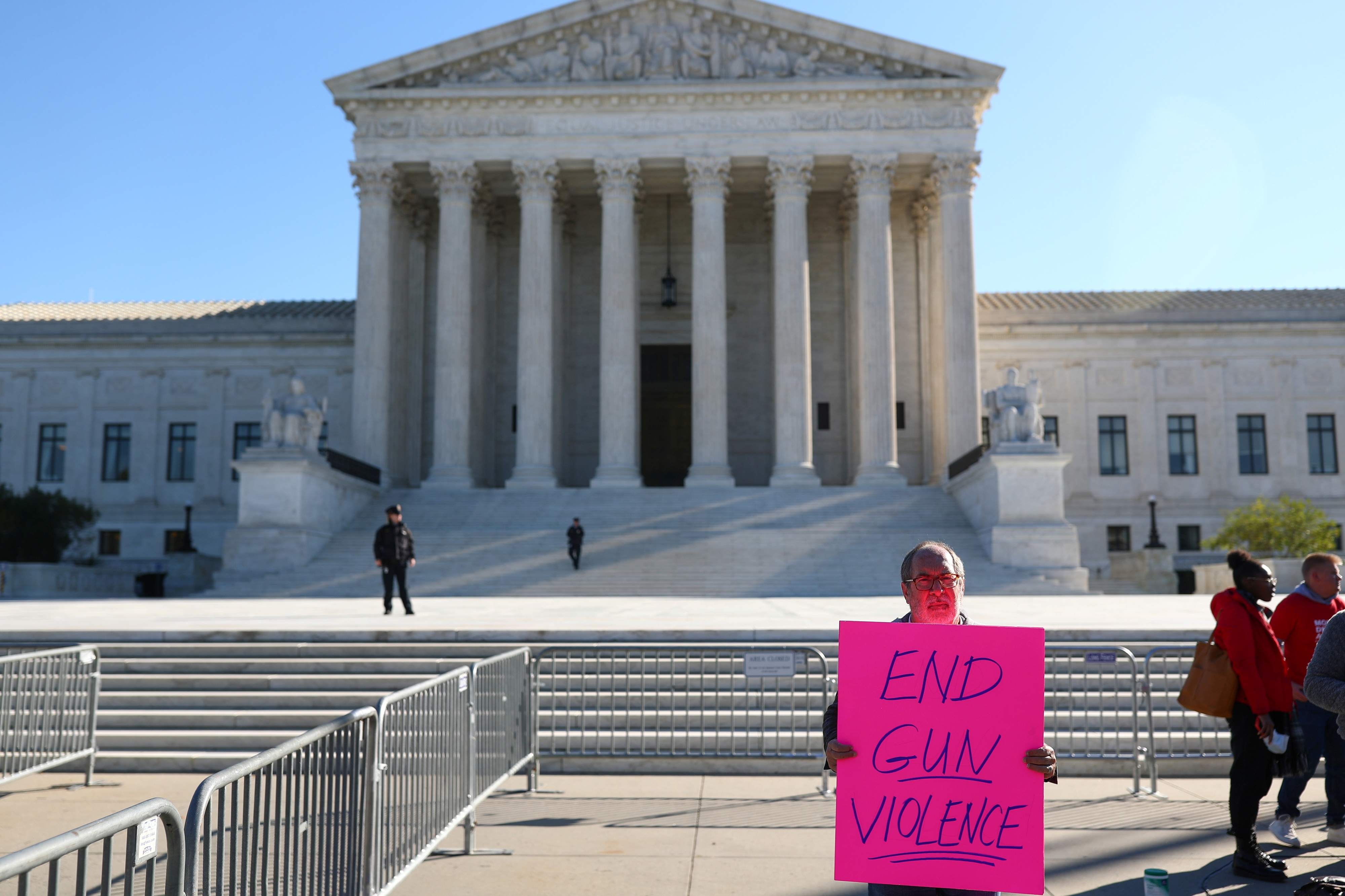 Reverend Patrick Mahoney stands while displaying a sign calling for an end to gun violence during a demonstration at the U.S. Supreme Court in Washington, U.S., November 3, 2021. REUTERS/Tom Brenner