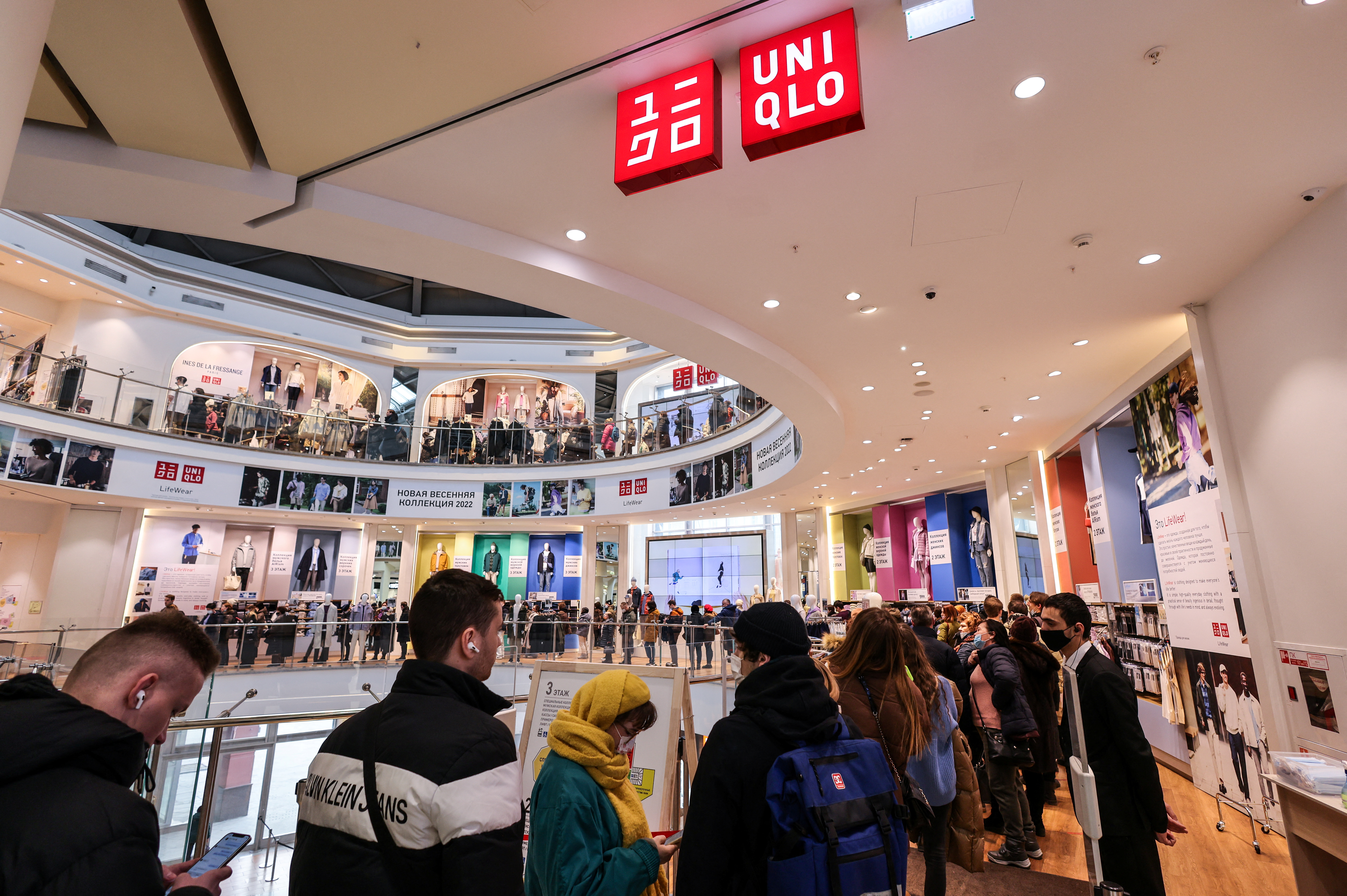 Customers queue to enter a Uniqlo store in Moscow