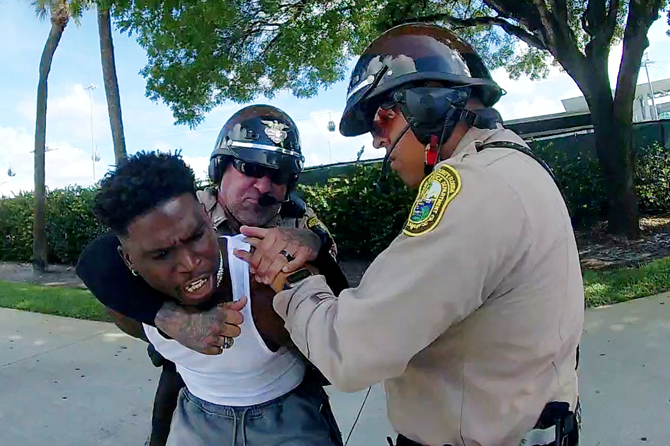 Miami Dolphins receiver Tyreek Hill is forced from his vehicle by Miami-Dade Police Department officers in Miami