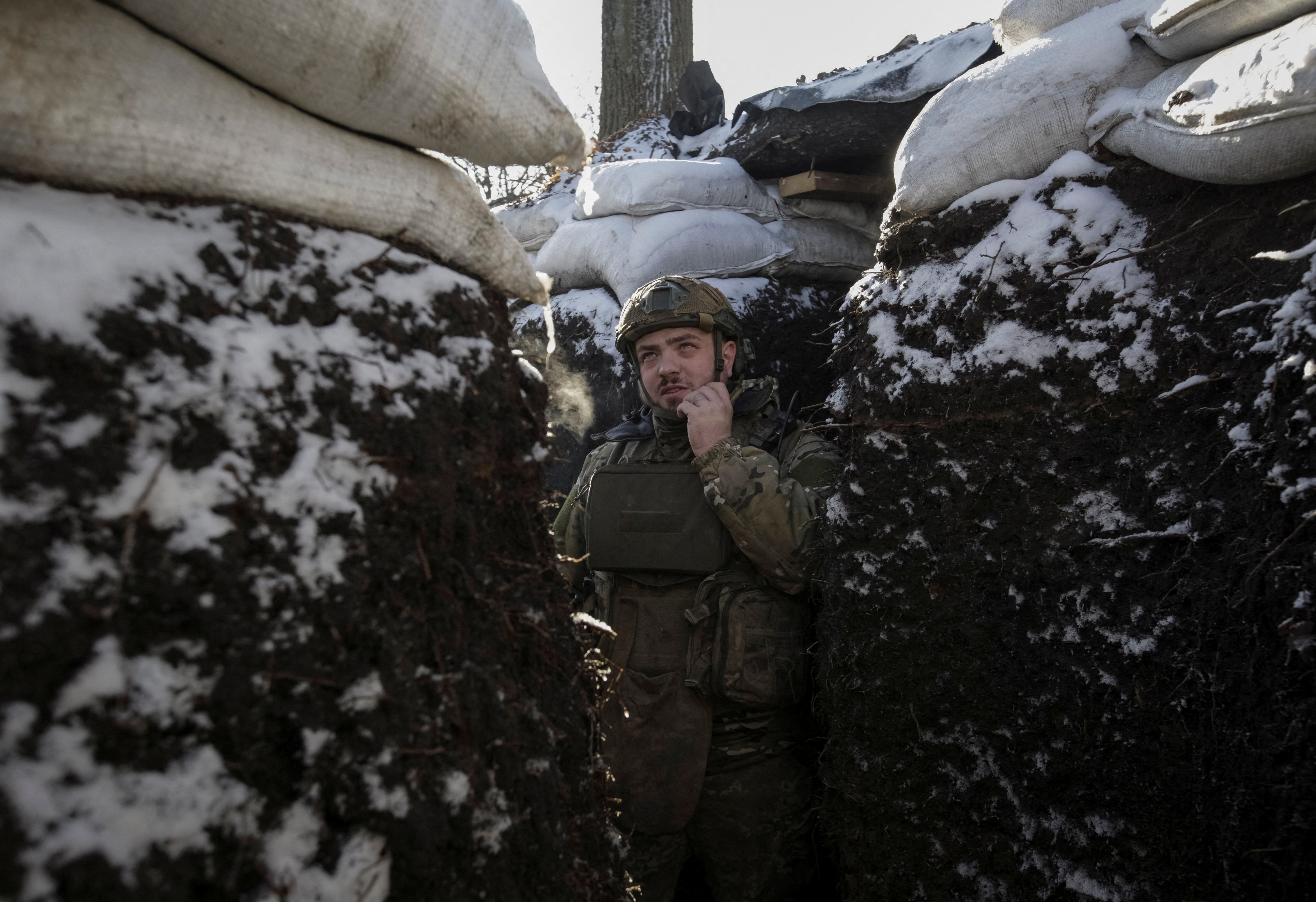 A Ukrainian serviceman stands in a trench at a frontline in Donetsk region