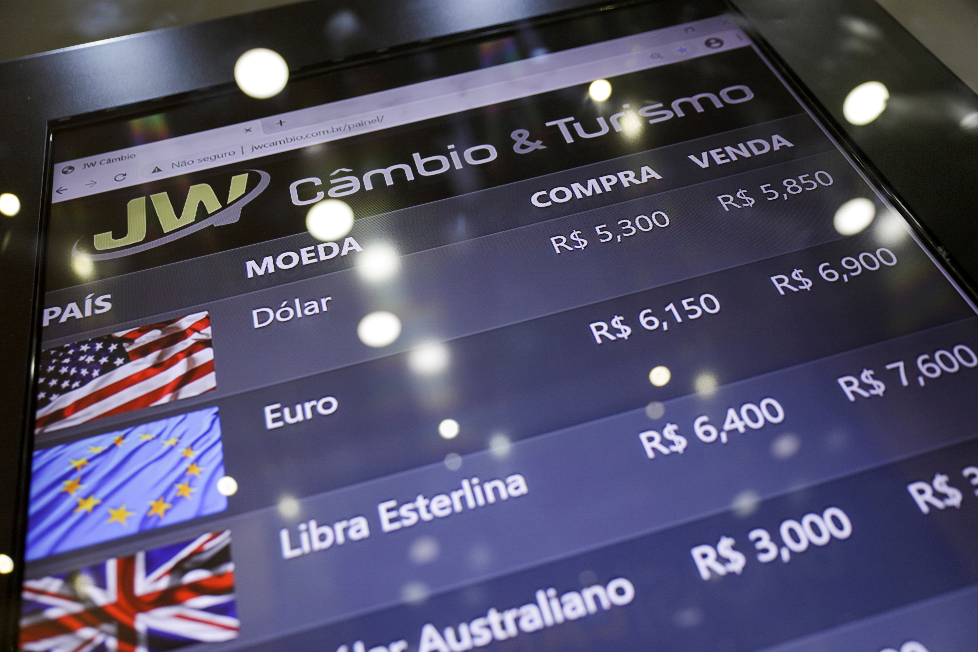 An electronic board shows currency exchange rates in Rio de Janeiro, Brazil March 9, 2021. REUTERS/Ricardo Moraes/File Photo