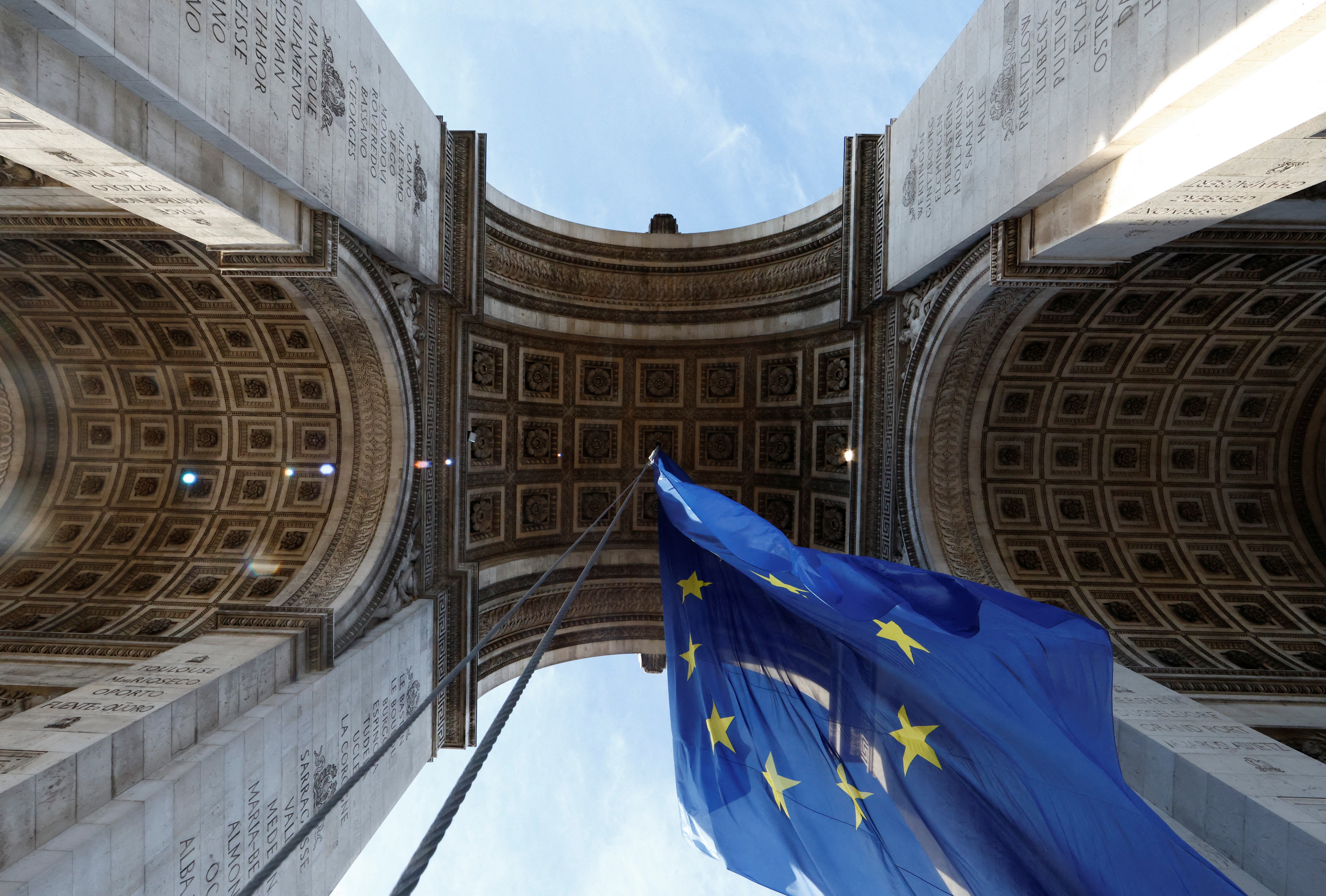The European flag flies under the Arc de Triomphe to celebrate the start of the French presidency of the European Union, in Paris, France, January 1, 2022. REUTERS/Christian Hartmann