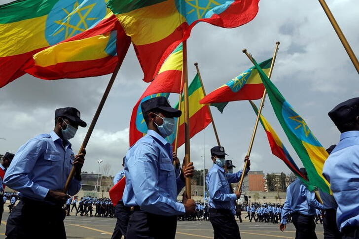 Addis Ababa police officers holding the Ethiopian national flags, take part in a parade to display their new uniforms, and their readiness for the upcoming Ethiopian parliamentary and regional elections, in Addis Ababa