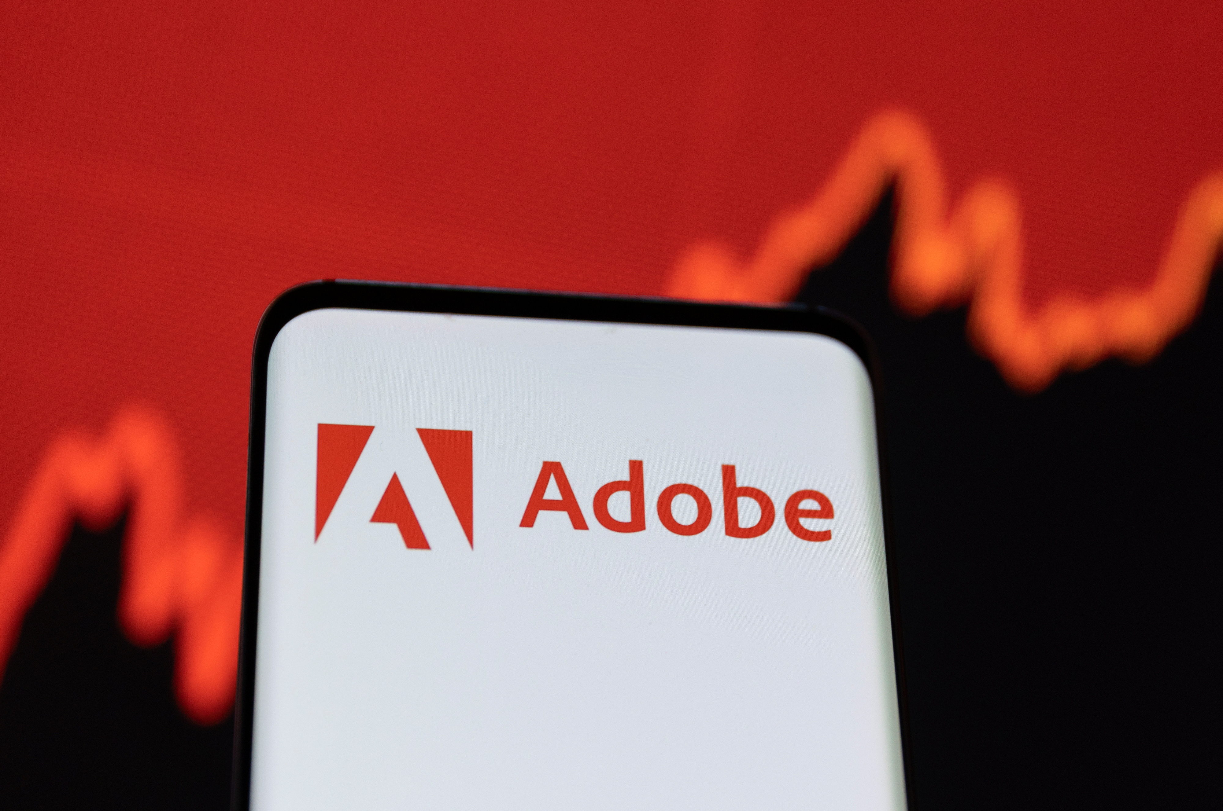 Illustration shows Adobe logo and stock graph