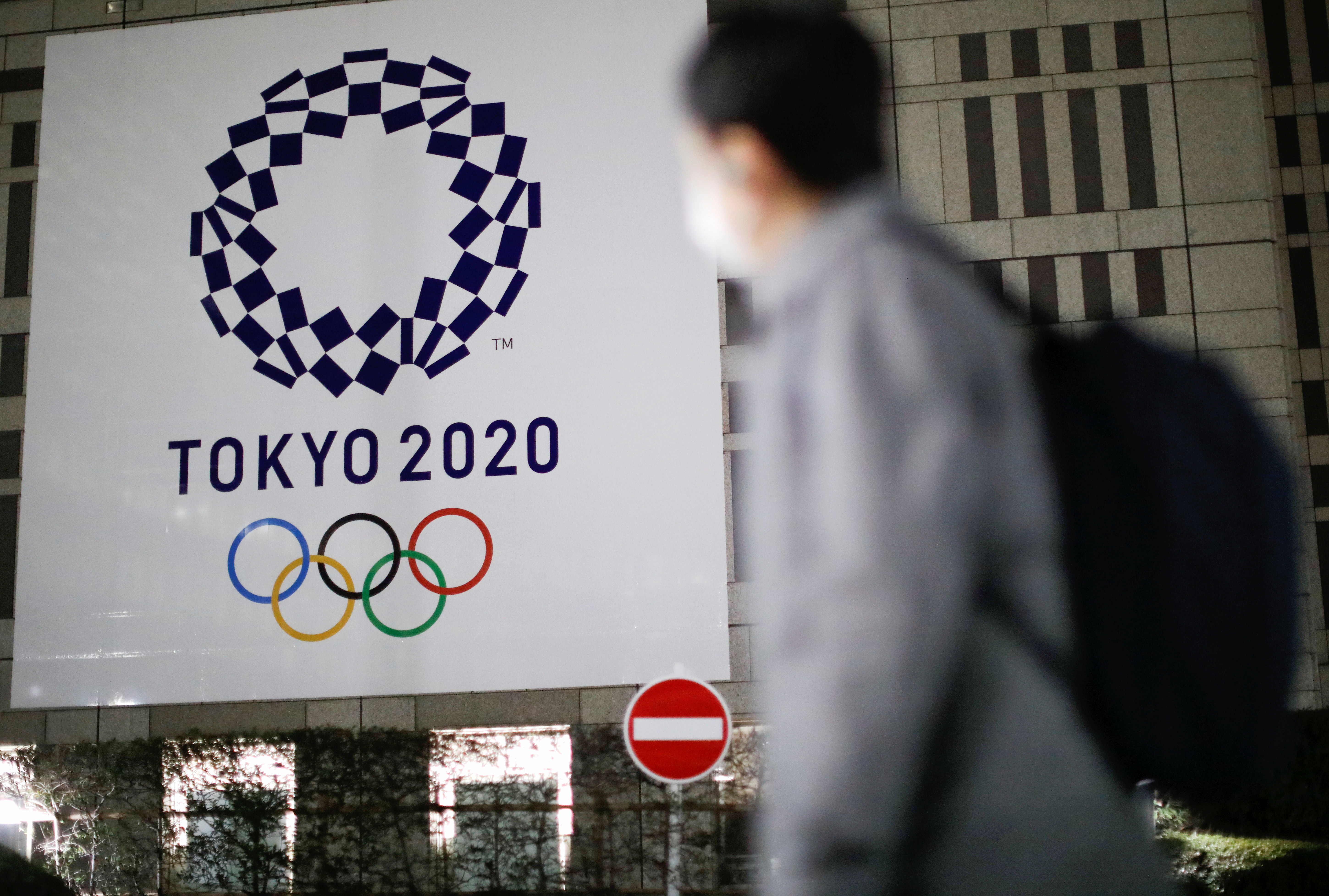 The logo of Tokyo 2020 Olympic Games is seen through signboards, in Tokyo