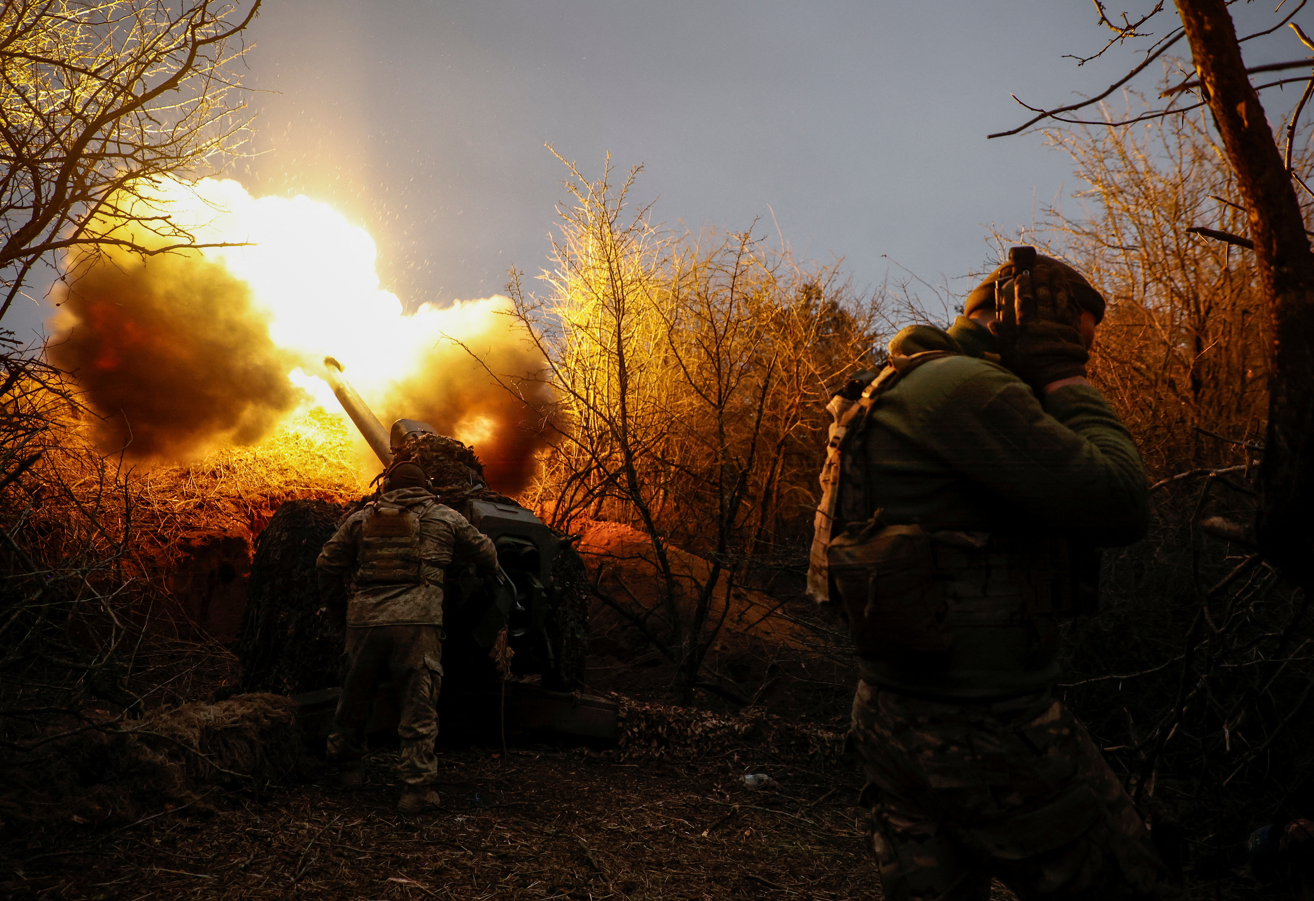 Ukrainian serviceman fire a D-30 howitzer towards Russian troops at a position in a front line in Kherson region