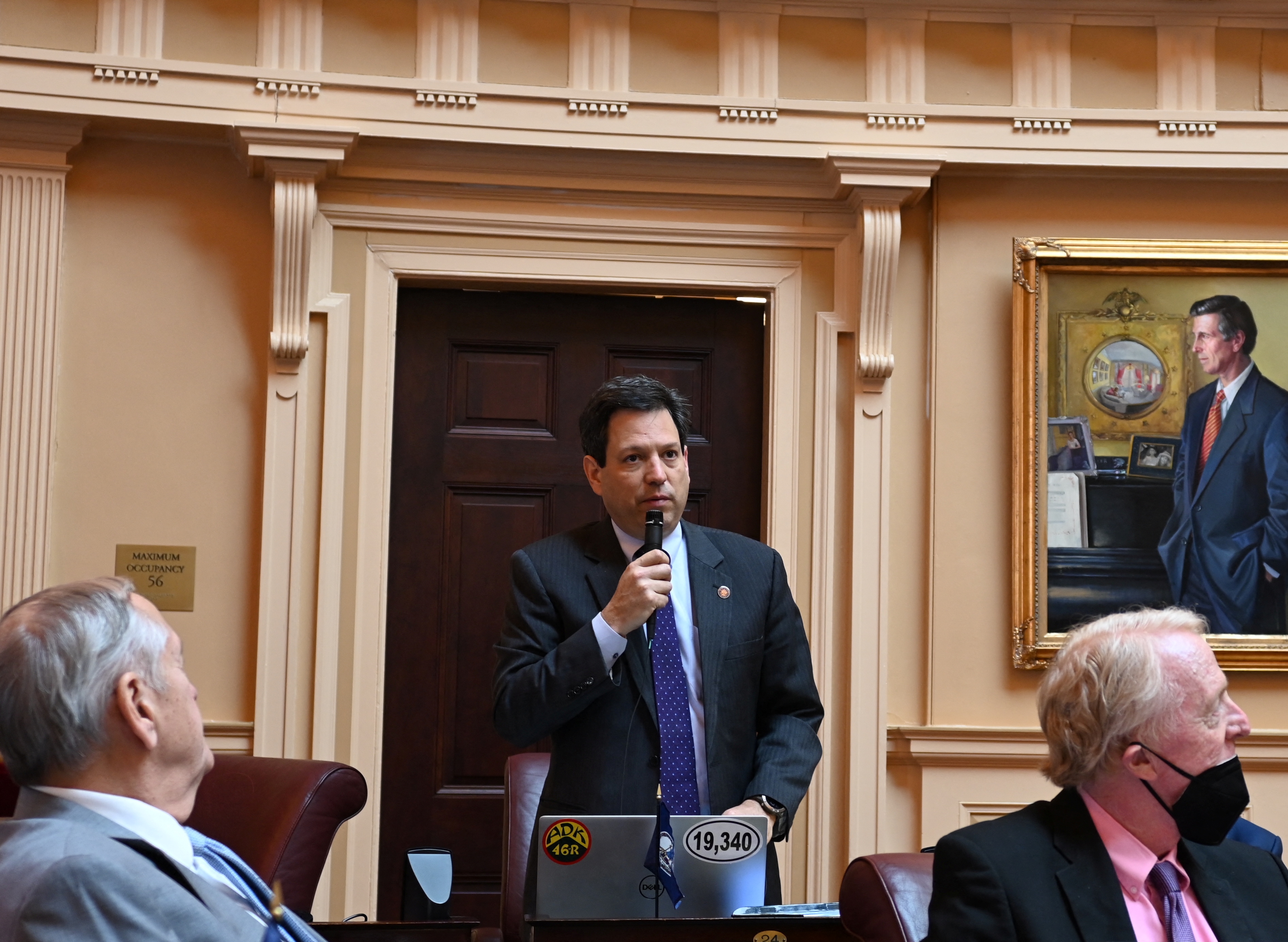 Virginia State Senator Scott Surovell, who sponsored legislation to allow for police use of facial recognition, speaks holding a microphone during a senate session, in Richmond