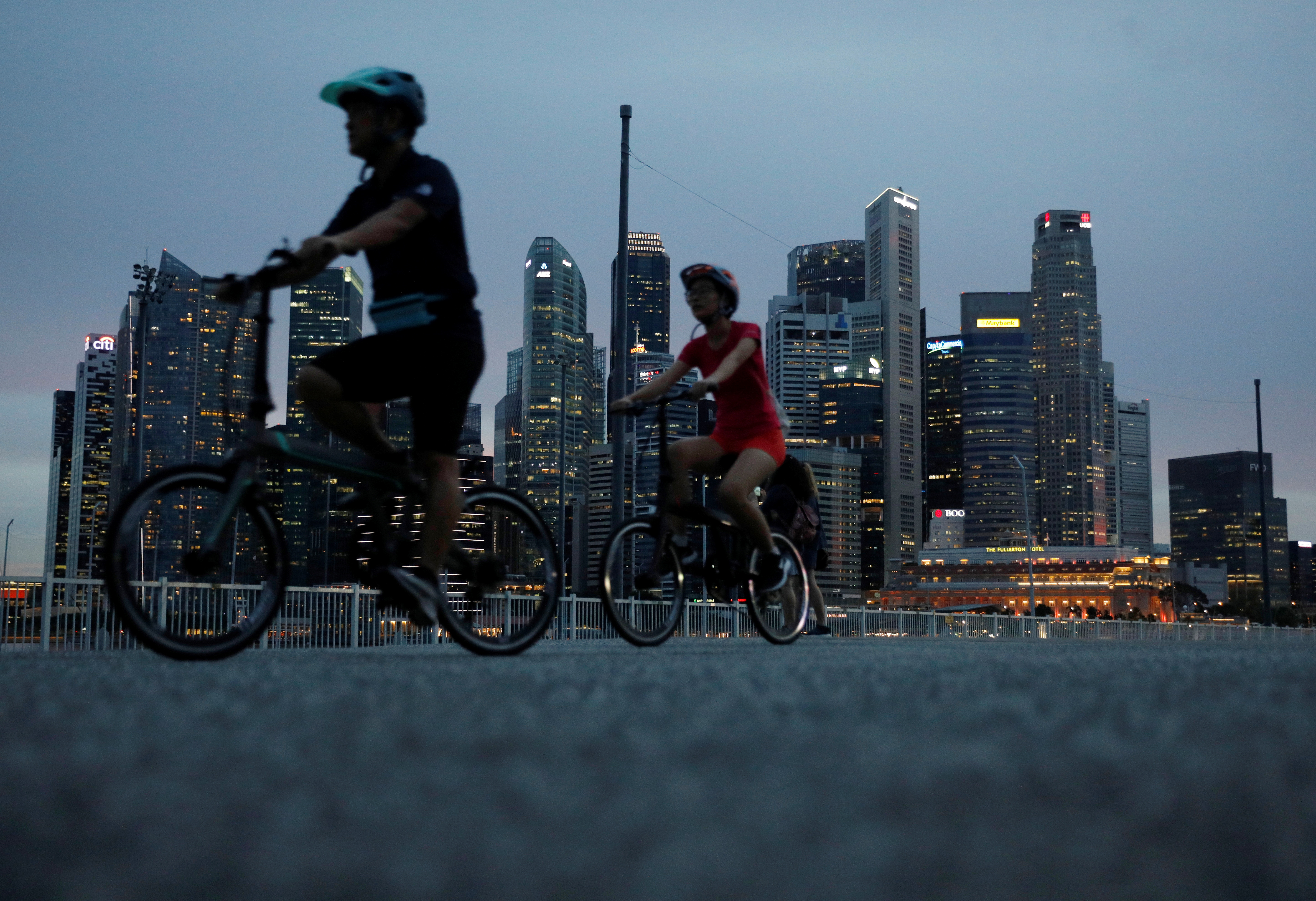 Cyclists pass the city skyline during the COVID-19 outbreak, in Singapore