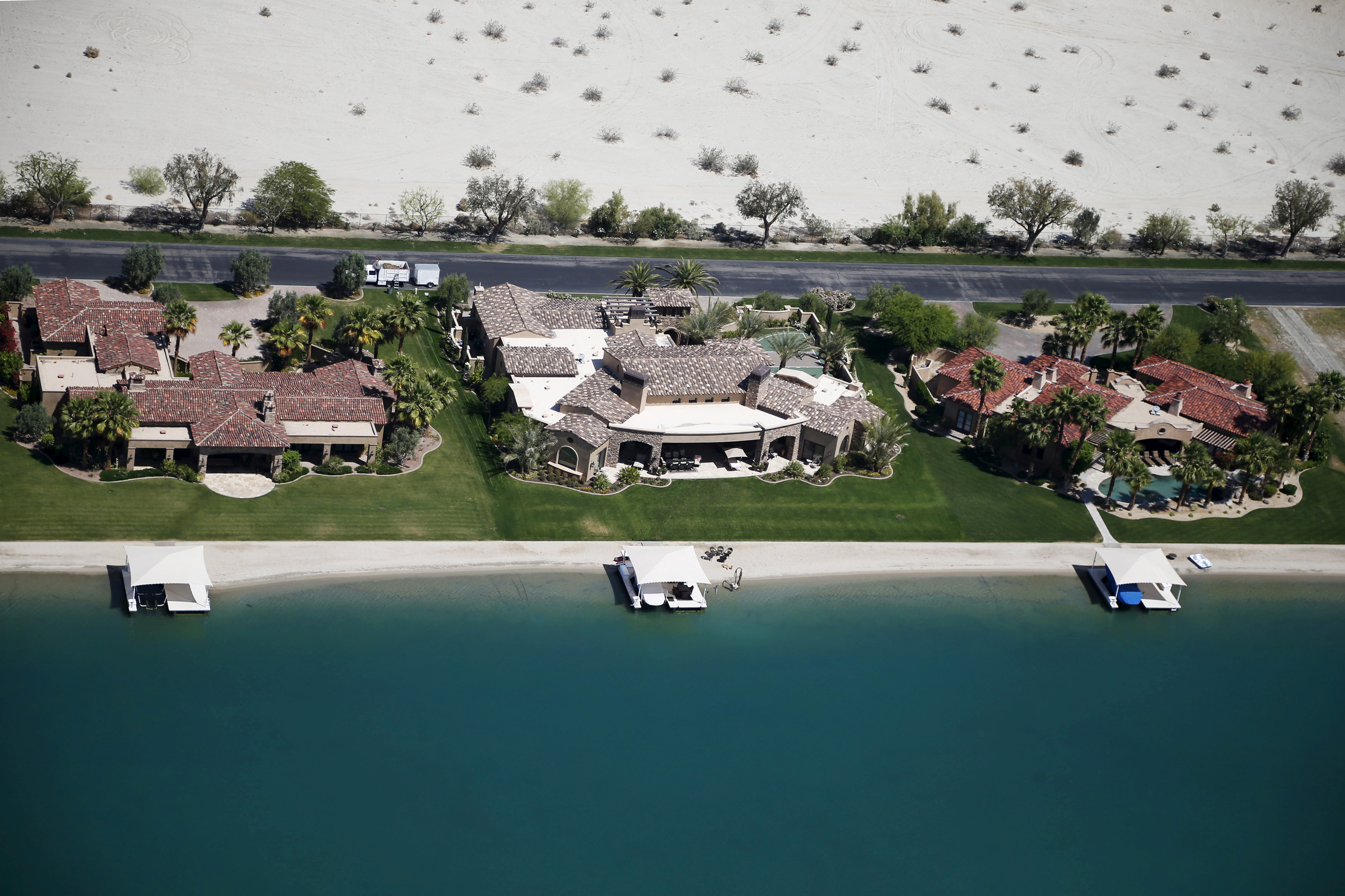 Homes with boathouses built around an artificial lake are seen in Indio