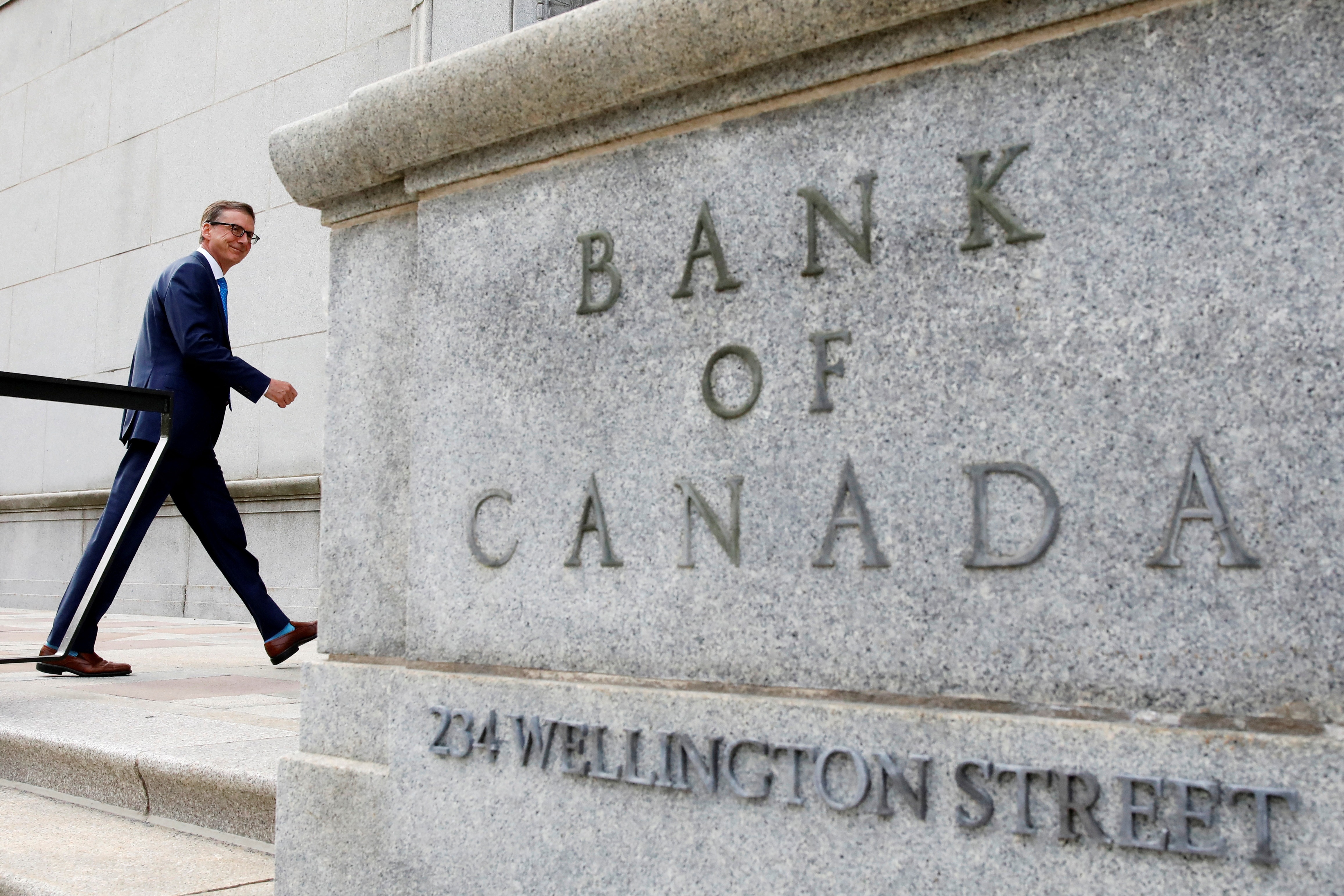 Governor of the Bank of Canada Tiff Macklem walks outside the Bank of Canada building in Ottawa