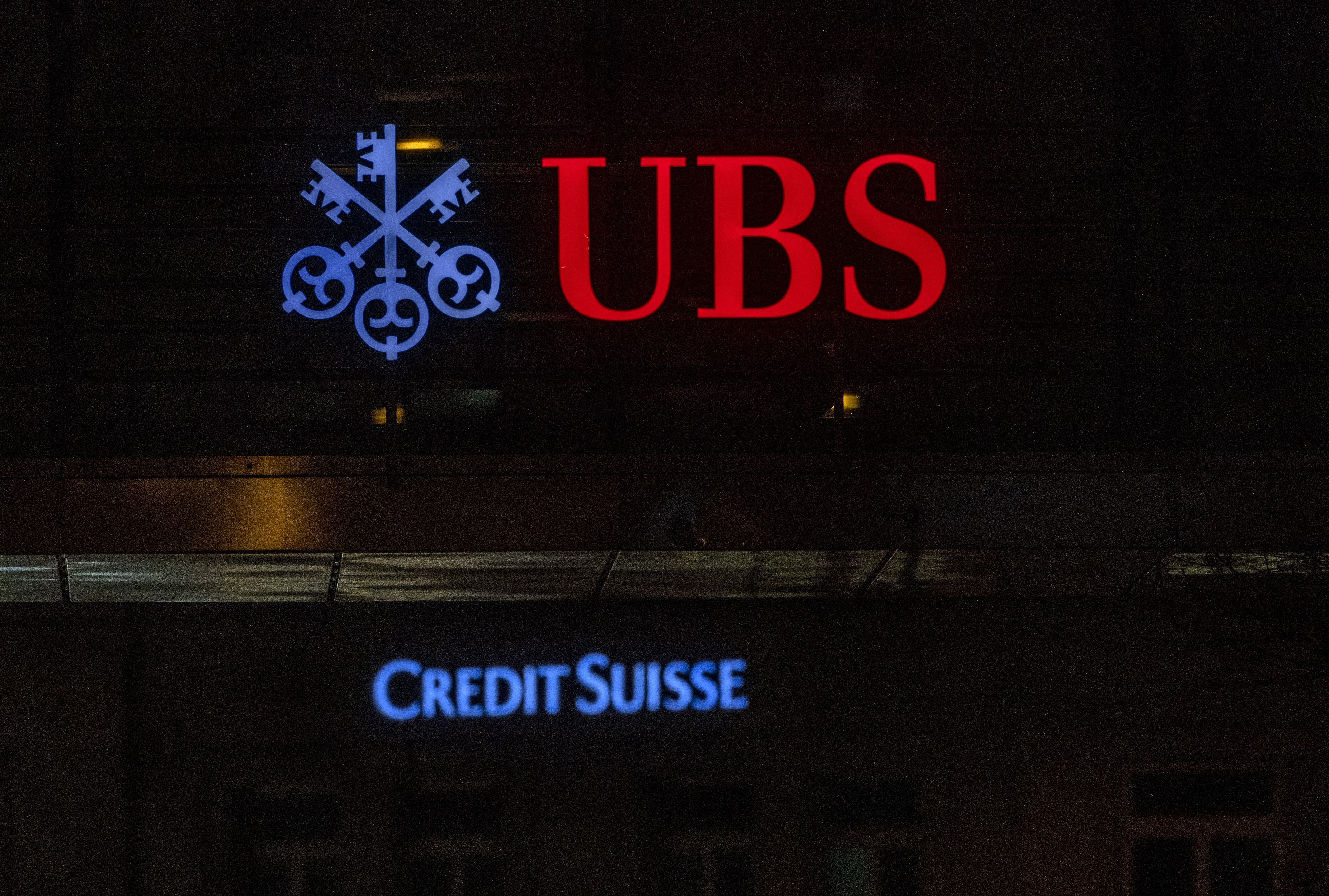 UBS and Credit Suisse banks logos are seen in Zurich