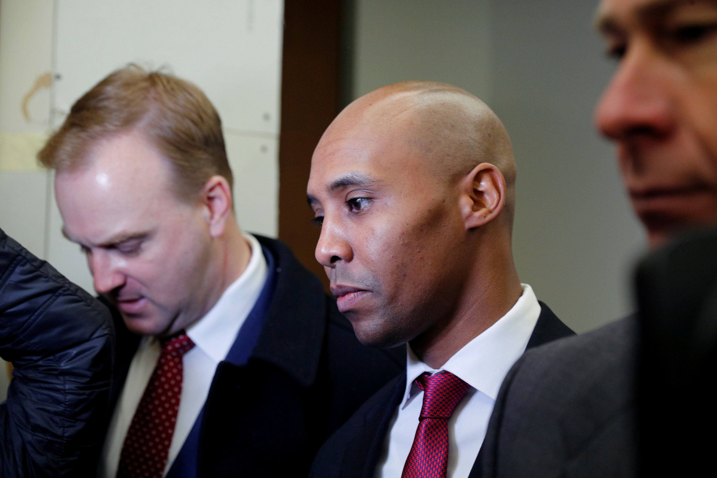 Attorneys Peter Wold, Thomas Plunkett and Mohamed Noor enter the courthouse prior to the start of the murder trial of former Minneapolis police officer Mohamed Noor in Minneapolis