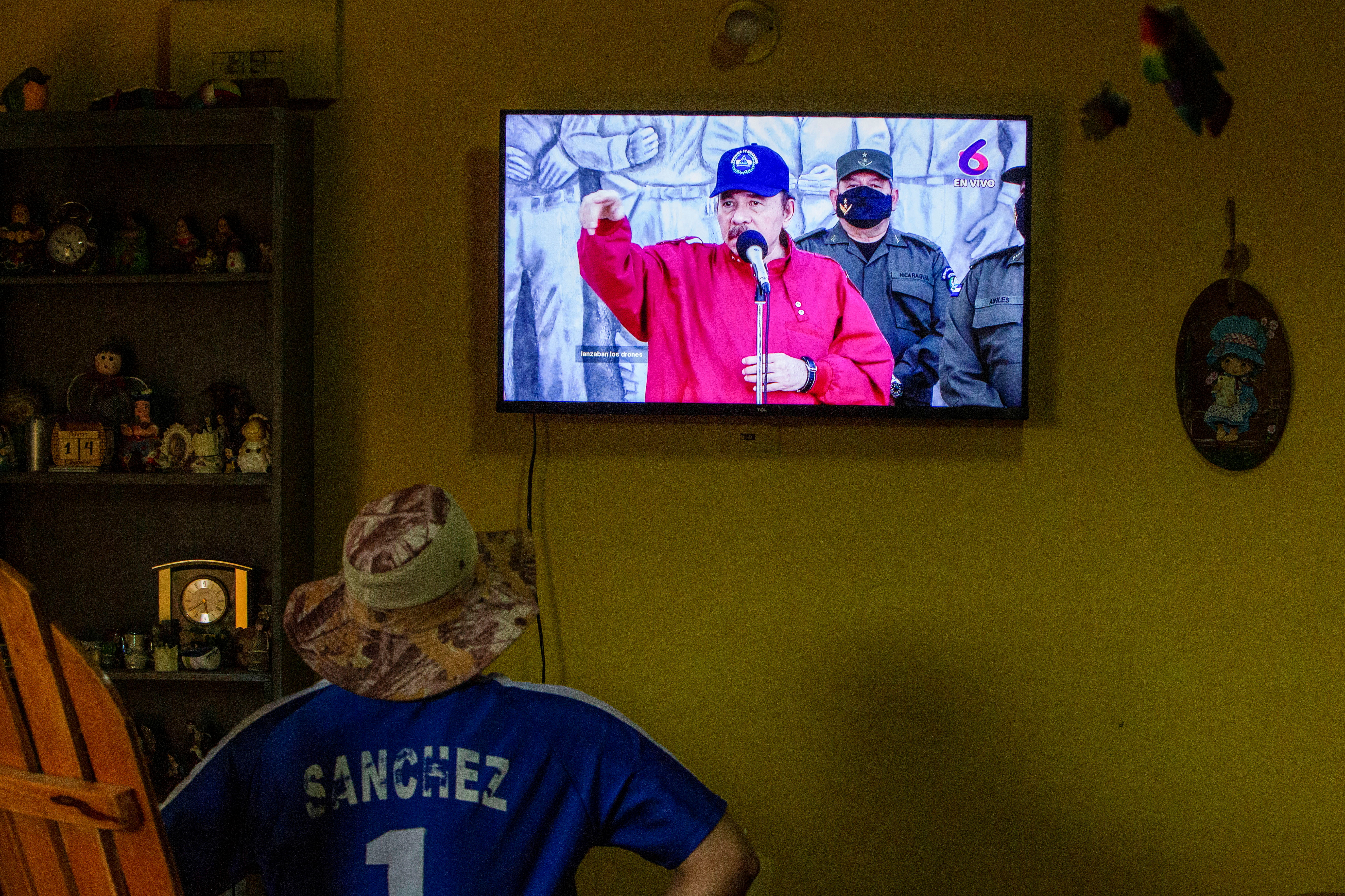 A man watches a televised speech of Nicaraguan President Daniel Ortega, in Managua