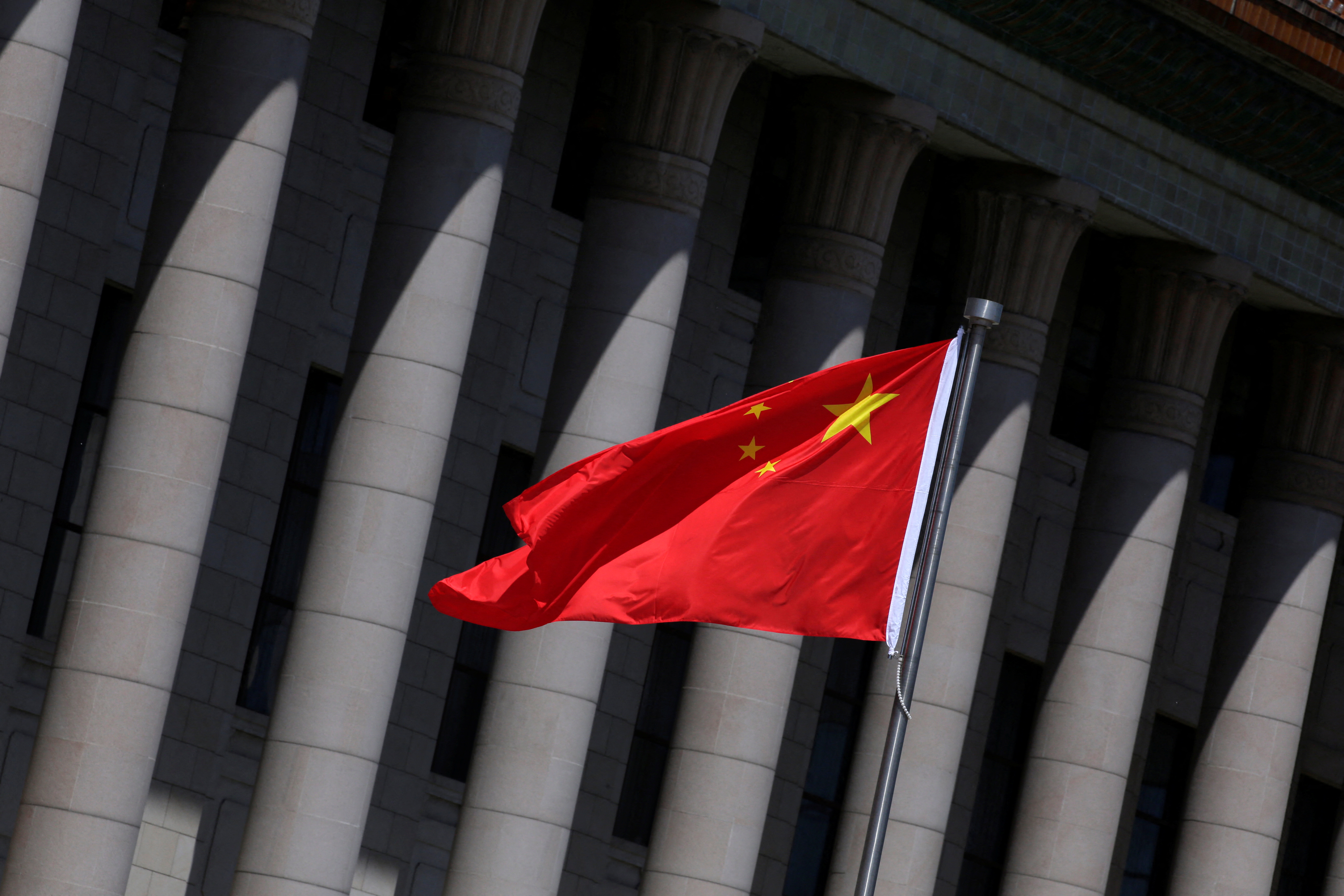 Chinese flag flutters in front of the Great Hall of the People in Beijing