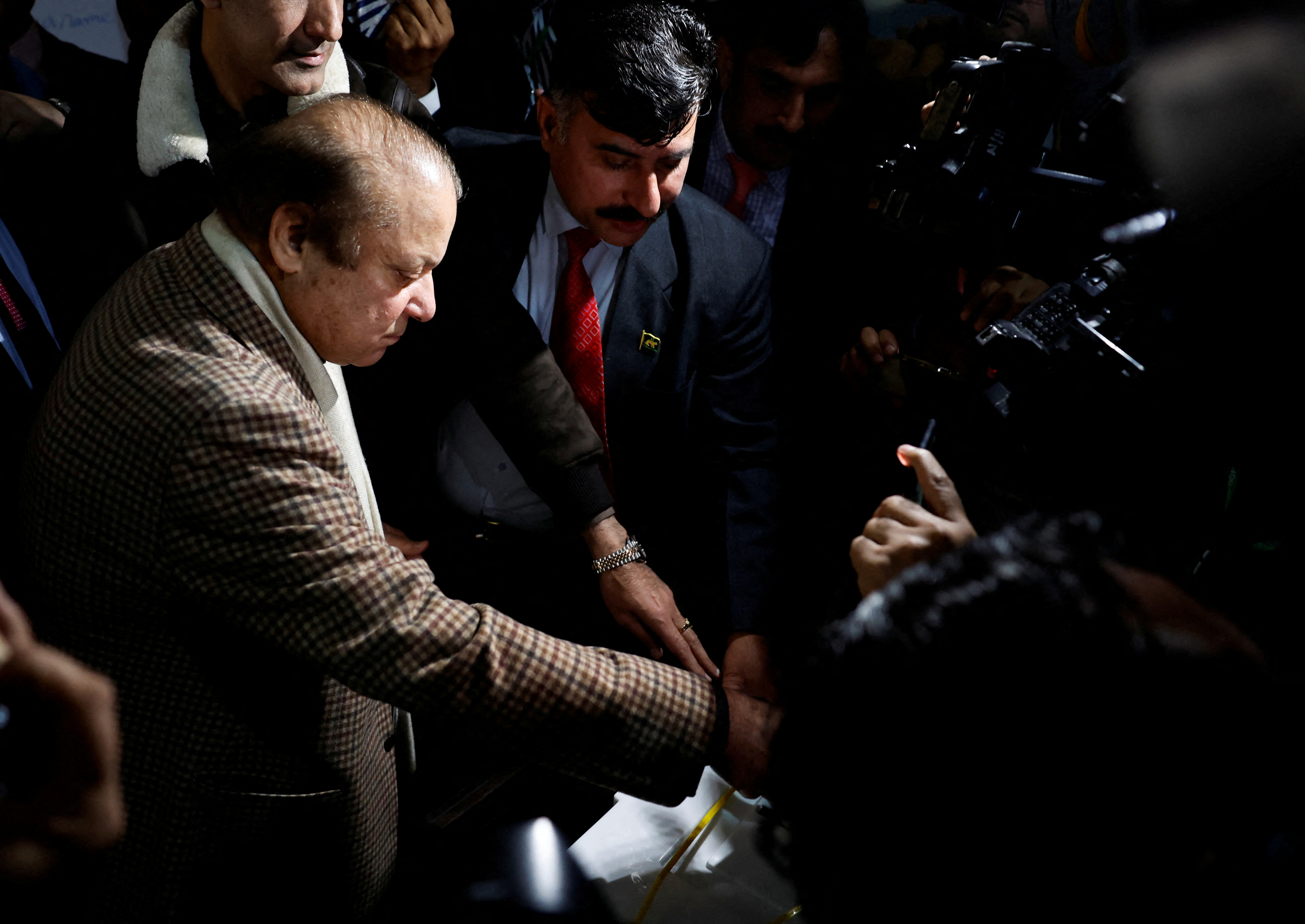 Former Prime Minister Nawaz Sharif casts his vote at a polling station during the general election, in Lahore
