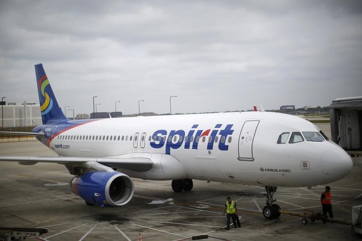A Spirit Airlines airplane sits at a gate at the O'Hare Airport in Chicago, Illinois