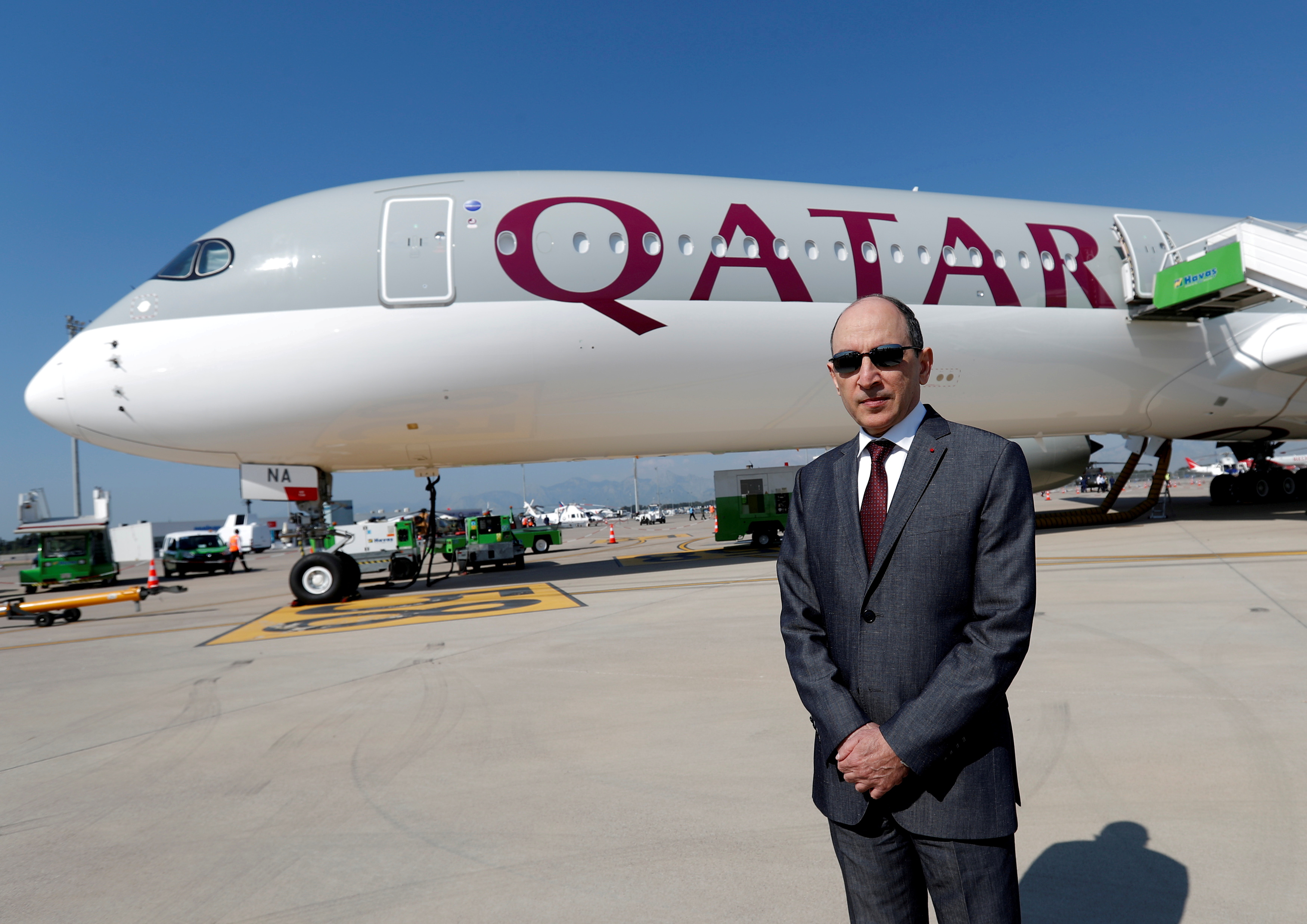 Qatar Airways Chief Executive Officer Akbar al-Baker poses in front of an Airbus A350-1000 at the Eurasia Airshow in the Mediterranean resort city of Antalya