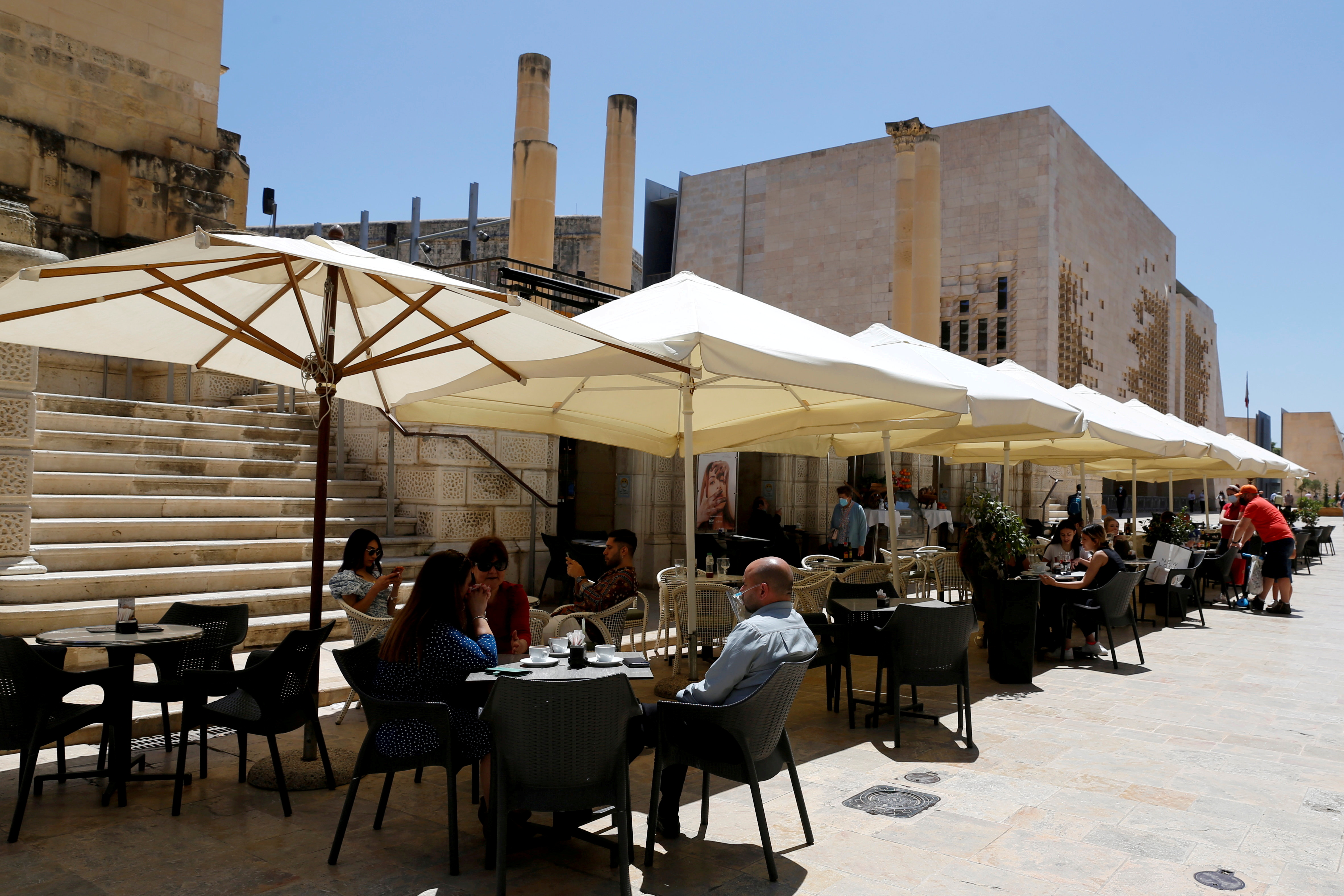 People sit at an outdoor restaurant as restaurants and markets reopened for business after coronavirus disease (COVID-19) vaccinations reached 60% of the adult population, in Valletta, Malta May 10, 2021.