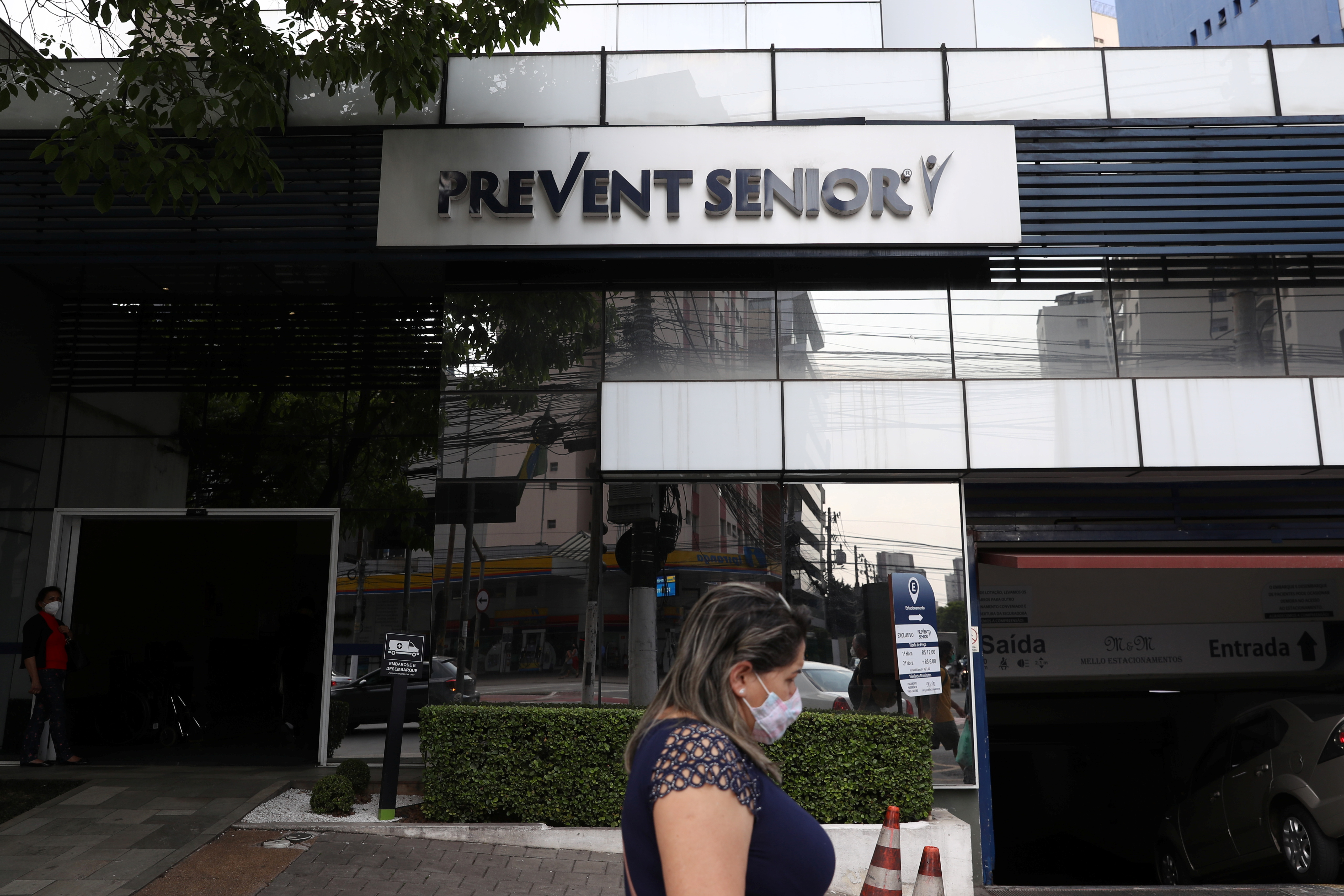A woman passes by the entrance of a Prevent Senior hospital chain unity in Sao Paulo, Brazil September 28, 2021. REUTERS/Amanda Perobelli