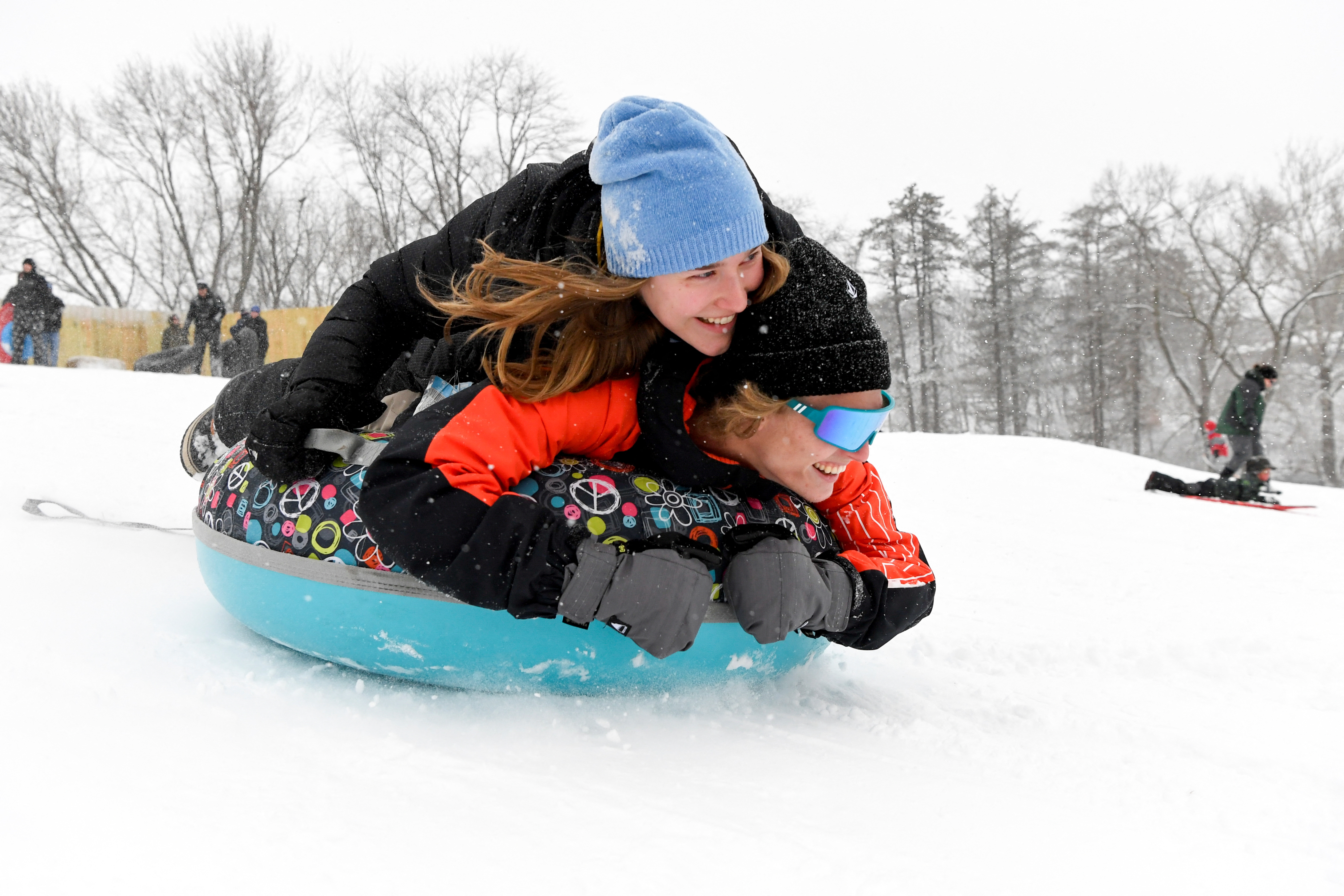 People sled during a snowstorm in Maumee, Ohio