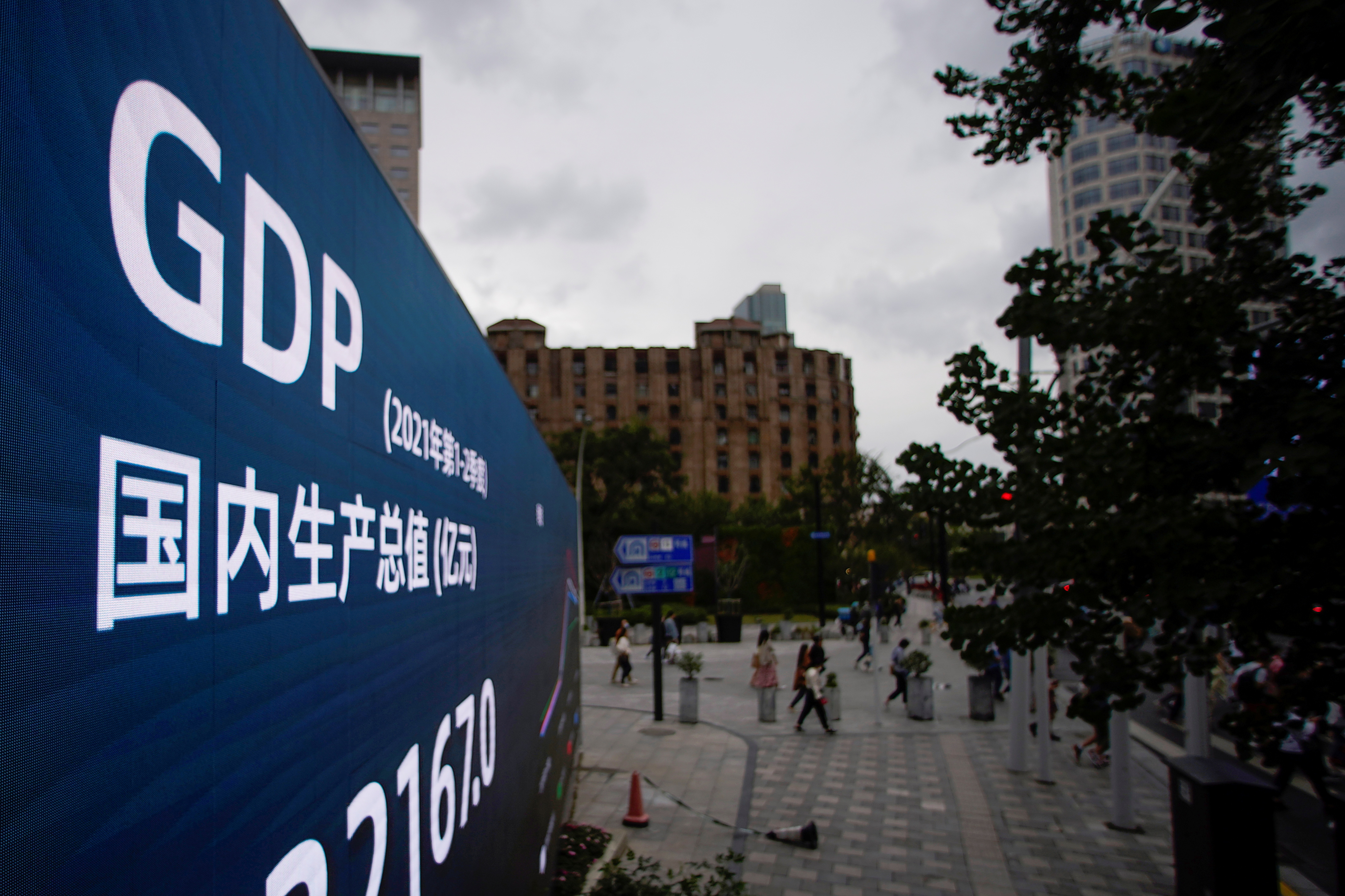 An electronic display showing the China GDP indexes is seen on a street in Shanghai