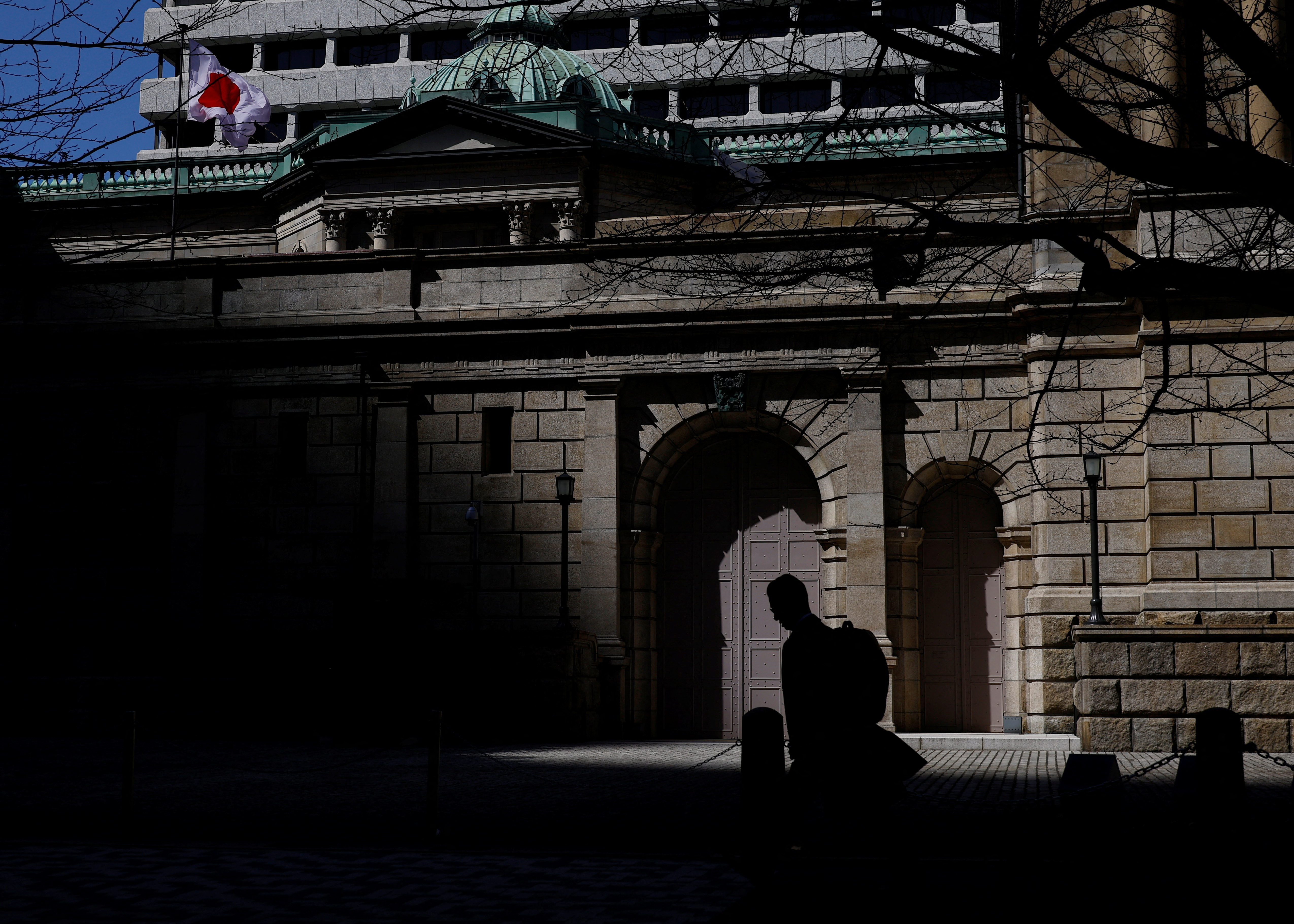 A man walks past the Bank of Japan building in Tokyo