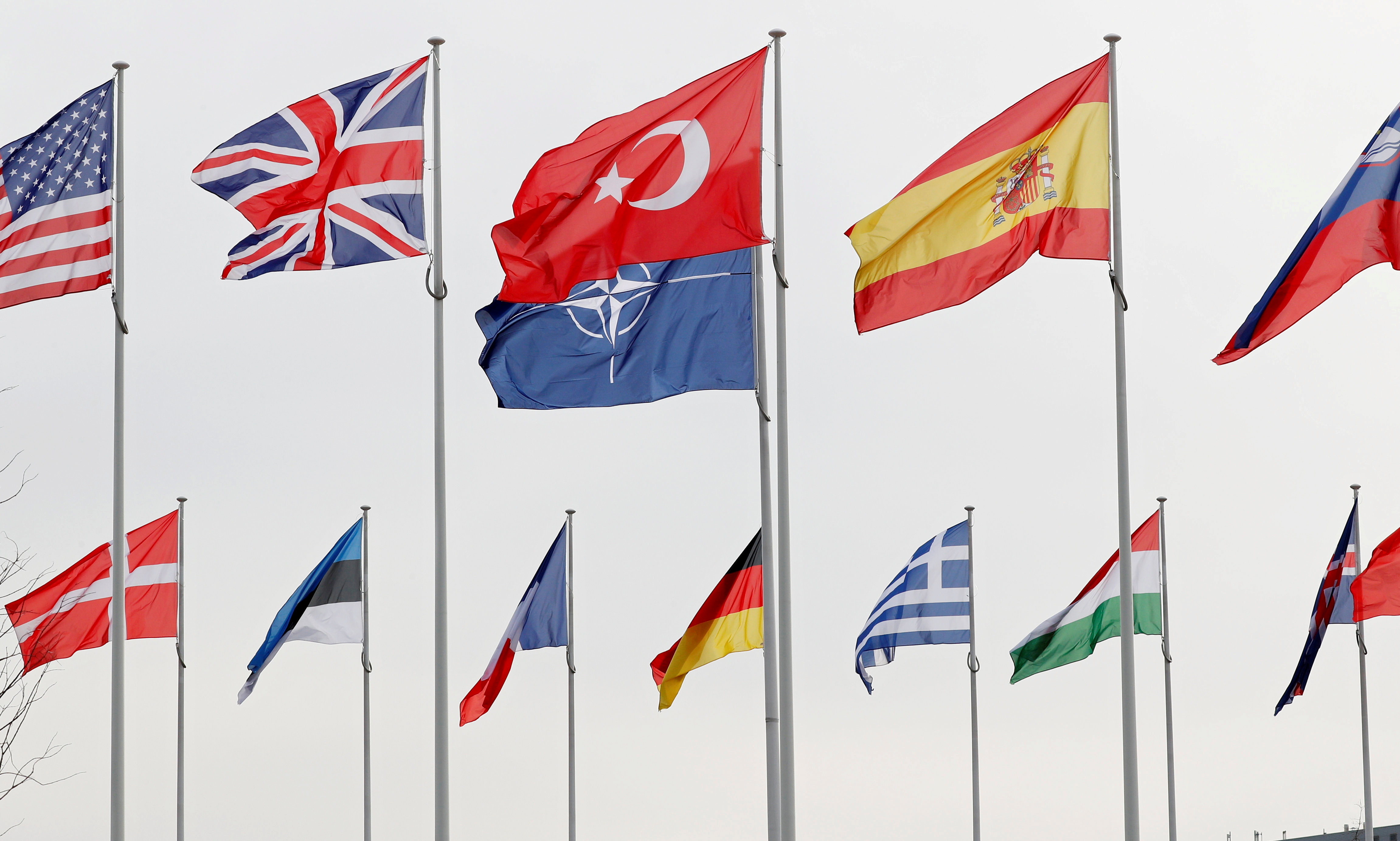 Flags of NATO member countries flutter at alliance headquarters in Brussels